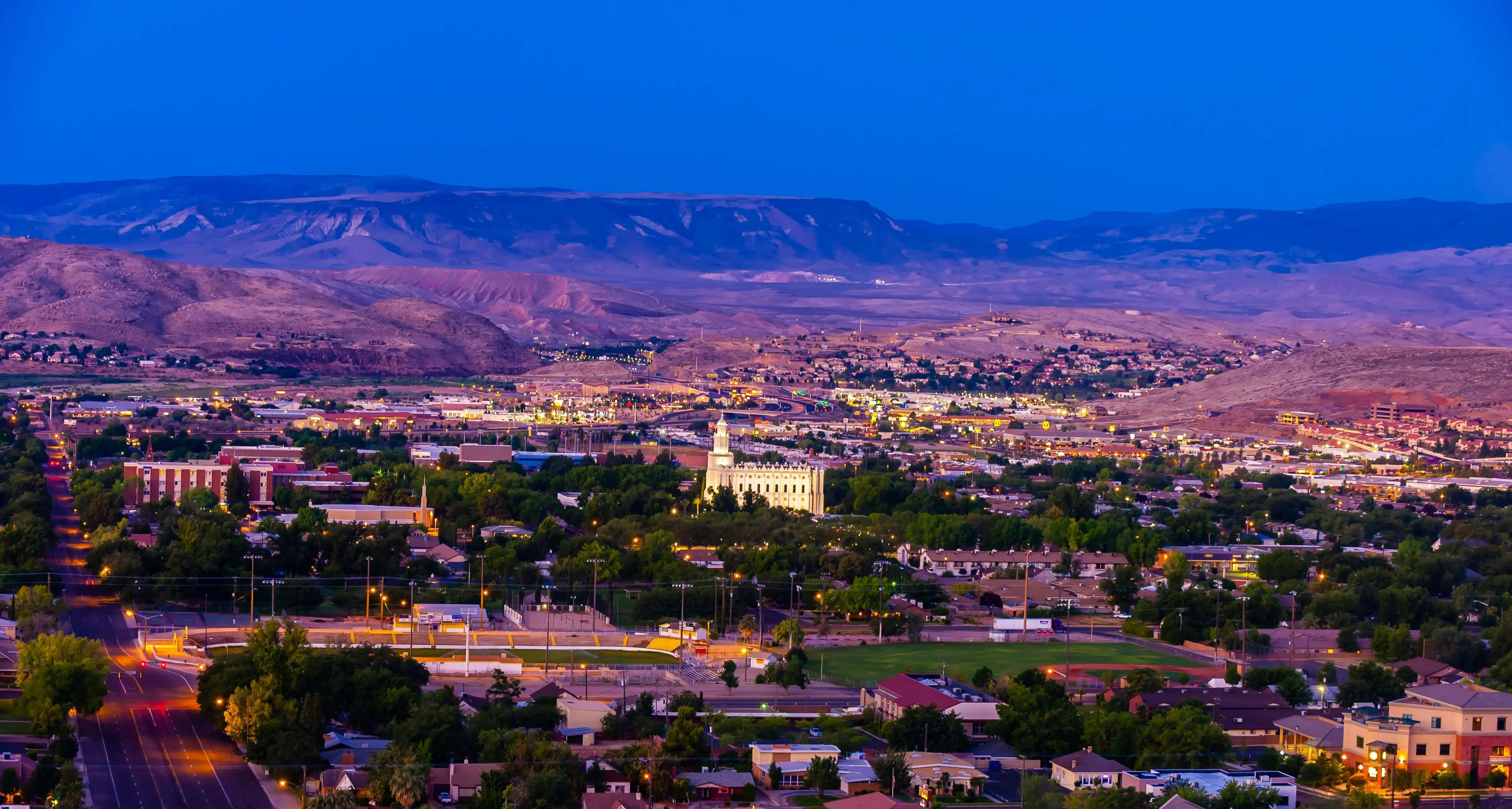 Saint George, Utah, and its surrounding areas are highly desirable places to move to for a variety of reasons:

1. **Sunny Climate:** Saint George enjoys over 300 days of sunshine per year, making it an ideal location for those who prefer warm, dry weather.

2. **Outdoor Paradise:** The region offers easy access to stunning national parks and recreational areas, including Zion National Park, Snow Canyon State Park, and the red rock landscapes of Southern Utah. Residents can enjoy hiking, rock climbing, mountain biking, and other outdoor activities.

3. **Retirement Destination:** Saint George has been recognized as a top retirement destination due to its mild climate, low crime rate, quality healthcare facilities, and a wide range of amenities catering to retirees.

4. **Golfing:** The area is a golfer's paradise, with numerous golf courses offering scenic views and challenging gameplay for enthusiasts of all skill levels.

5. **Cultural Scene:** Saint George has a vibrant arts and cultural scene, with art galleries, theaters, museums, and annual events like the St. George Art Festival and the St. George Marathon.

6. **Educational Opportunities:** The town is home to Dixie State University, providing educational resources and programs for students of all ages.

7. **Thriving Economy:** The area boasts a strong economy supported by sectors like tourism, healthcare, and outdoor recreation, providing ample job opportunities for residents.

8. **Community Spirit:** Saint George has a strong sense of community and a welcoming atmosphere, making it a great place for families, retirees, and young professionals alike.

9. **Quality of Life:** With low crime rates, high-quality healthcare facilities, a range of dining and shopping options, and a focus on outdoor recreation, Saint George offers a high standard of living.

Overall, the desirable qualities of Saint George make it an attractive destination for those seeking a vibrant and fulfilling lifestyle.