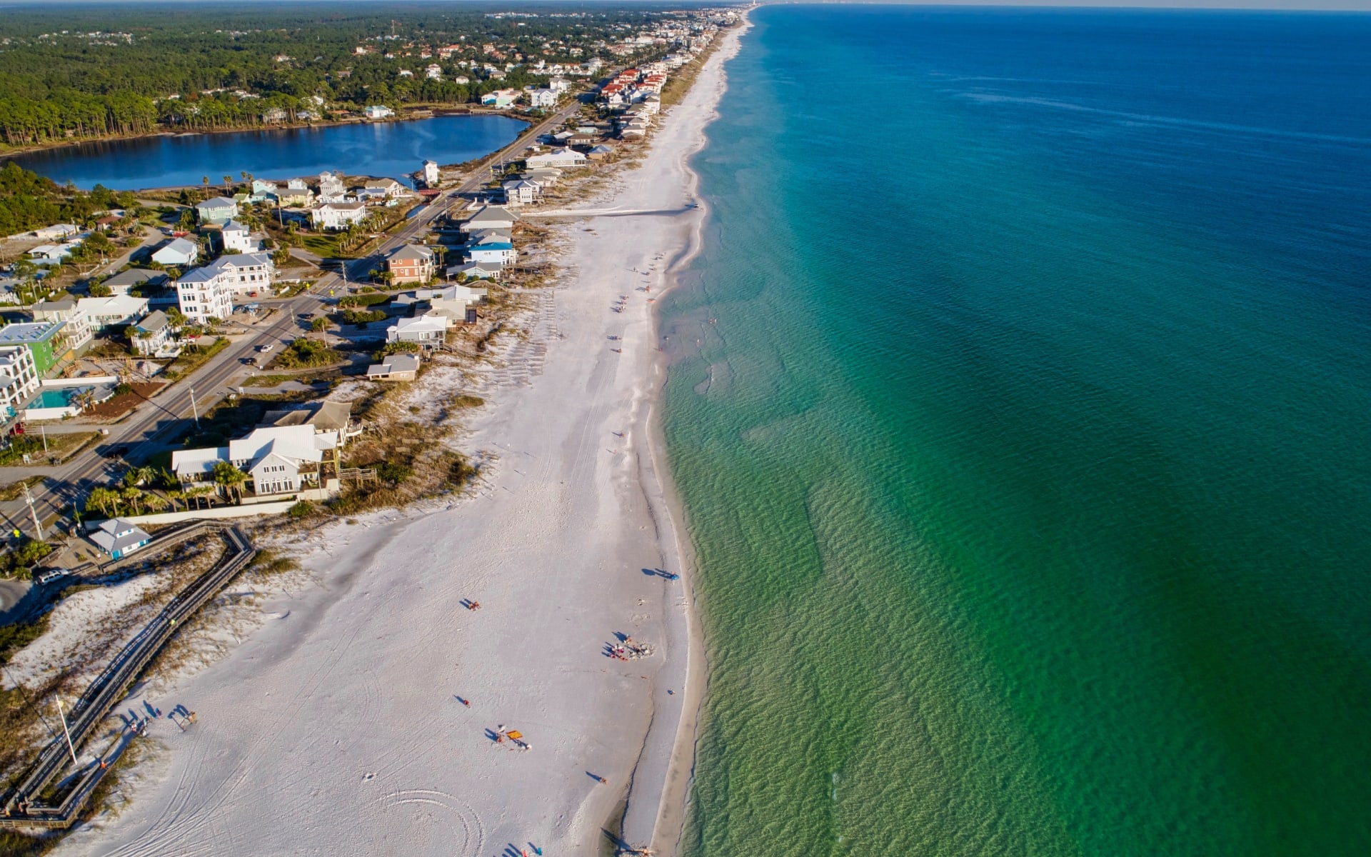 Seagrove Beach is a charming coastal community located along scenic Highway 30A in the Florida Panhandle. It's known for its beautiful white sand beaches, crystal-clear turquoise waters, and picturesque surroundings, making it a popular destination for visitors seeking a tranquil and relaxed beach experience.

One of the notable features of Seagrove Beach is its natural beauty. The area is characterized by an abundance of native vegetation, including coastal dune lakes, pine forests, and sand dunes. This creates a unique and peaceful atmosphere that draws nature enthusiasts and explorers.

Seagrove Beach offers a range of outdoor activities for visitors to enjoy. The pristine beaches provide opportunities for swimming, sunbathing, and beachcombing. You can also rent paddleboards or kayaks to explore the coastal dune lakes or take a leisurely bike ride along the scenic 30A bike path.

The community has a laid-back vibe with charming beach cottages and vacation rentals that enhance the coastal ambiance. You'll find a few locally-owned shops, galleries, and restaurants in Seagrove Beach, offering a diverse selection of cuisine, from fresh seafood to Southern comfort food.

Seagrove Beach is conveniently located near other popular 30A communities, allowing visitors to explore neighboring towns and beaches. Nearby attractions include Grayton Beach State Park, Camp Helen State Park, and the lively town of Seaside, known for its unique architecture and vibrant atmosphere.

Overall, Seagrove Beach on 30A provides a perfect blend of natural beauty, relaxation, and outdoor adventures, making it an ideal destination for a memorable beach vacation.