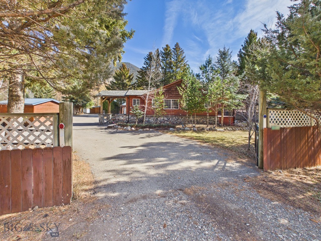 Open the gates and discover a thoughtfully built and extensively updated 2,409 square foot residence designed for comfortable living with room to expand. The main home offers three bedrooms and two bathrooms and has undergone substantial upgrades, including new wiring, HVAC, plumbing, insulation, membrane, wired smoke detectors, a Culligan water filtration and softening system, new 2x12 treated joists, new wood siding, and updated exterior lighting. The upstairs bathroom features a timeless antique clawfoot tub with waxed walls designed to repel water, blending character and durability. A practical mudroom adds everyday functionality, and the main home enjoys its own dedicated yard space within the larger property.

Beyond the primary residence, the property unfolds into a private compound setting with a large overall yard and exceptional flexibility. A separate cottage is fully ready for living and features its own fenced, private backyard along with dedicated storage — ideal for guests, multigenerational living, or supplemental income. Multiple storage units are positioned throughout the property, offering practical solutions for equipment, tools, or seasonal storage.

Additional structures further expand the possibilities, including a building ready to be finished as a future cottage or bunkhouse and another detached structure that would make an excellent private office, studio, or workspace for someone wanting to operate a business from home. The property also includes three detached garage spaces, including a heated garage currently used as storage with baseboard heat, an insulated shop, and a covered lean-to for additional storage. There is abundant parking throughout the property, including RV hookups, enhancing the ability to host guests, store recreational vehicles, or create additional income opportunities. 

This is a rare opportunity to own a private residence with built-in versatility, infrastructure, and room to grow — all behind the gates.