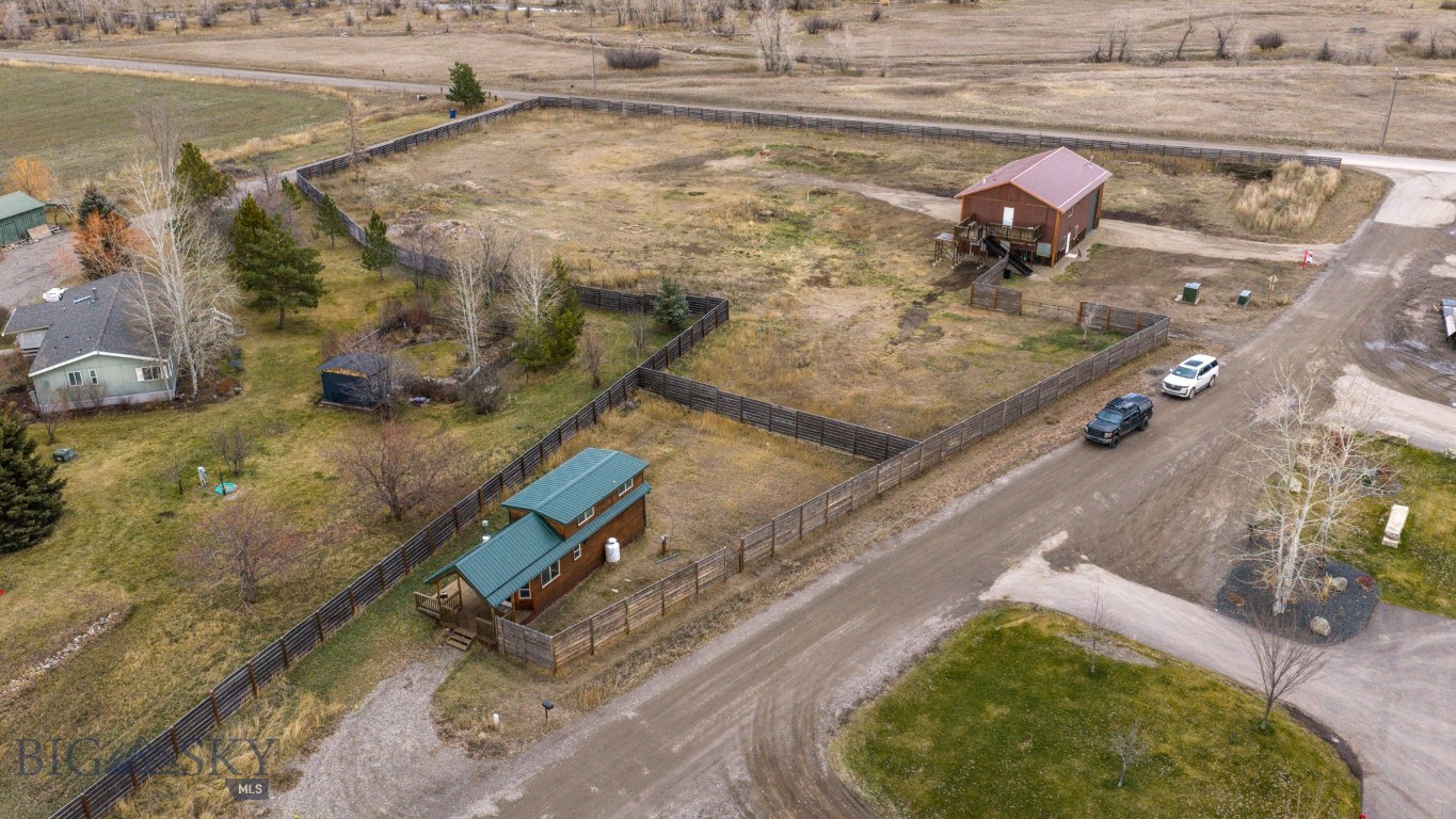 Discover a rare canvas of opportunity situated against the breathtaking backdrop of the Bridger Mountain range. This versatile 3-acre parcel offers a seamless, on site blend of residential and commercial utility, strategically located just minutes from the Bozeman Yellowstone International Airport and the amenities of both Belgrade and Bozeman. The property currently features a sophisticated live-work facility, comprised of a spacious office, an oversized garage, and a curated one-bedroom residence. Previously operating as a successful Airbnb with a strong rental history, this dwelling provides immediate turnkey income or a comfortable landing spot while you plan your future. Benefiting from flexible Neighborhood Commercial zoning, the possibilities are truly endless. Envision constructing your custom dream estate to capture the alpenglow, or expand the commercial footprint to suit your business needs. Whether you seek a private sanctuary with income potential or a base for your enterprise, this property invites you to define your own legacy in the Gallatin Valley.