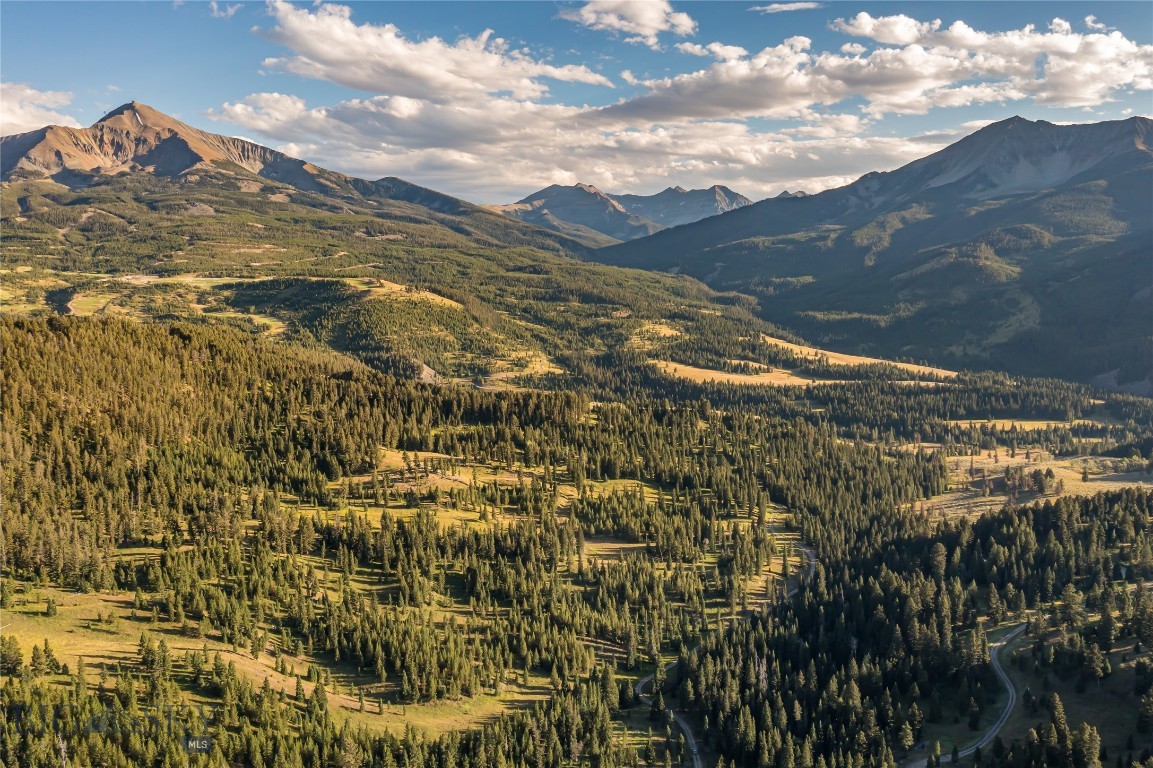Welcome to the distinguished Moonlight Territories, a rare haven within one of the country’s last vestiges of pristine mountain wilderness. Poised in the heart of Moonlight Basin, this legacy property unveils breathtaking 360° panoramas, extending from the grandeur of Spanish Peaks to the lofty peaks of Fan and Cedar Mountain, and the iconic Lone Mountain. Distinguished yet embracing, the landscape is adorned with mature evergreens, perfectly framing these awe-inspiring views from every vantage point, cultivating an atmosphere of seclusion that enriches your personal sanctuary. Set in nature, this property is connected by miles of recreational trails traversing the Territories, imparting a sense of being worlds away, all while maintaining close proximity to the unparalleled amenities synonymous with Moonlight Basin and One&Only Moonlight Basin, opening in 2025.  From world-class skiing at Big Sky Resort to tee times at the infamous Jack Nicklaus golf course, lake activities, winter pursuits, and so much more. The unspoiled beauty unfolds as far as the eye can see, with over 2,500 acres protected by a perpetual conservation easement. This legacy property stands as a testament to Moonlight Basin's commitment to preservation. Embark on a lifestyle where the unbroken charm of nature seamlessly integrates with the allure of exceptional access and amenities. Territory 5, one of several larger tracts within Moonlight Basin, invites you to experience the unparalleled luxury of living while embracing the beauty of the land.