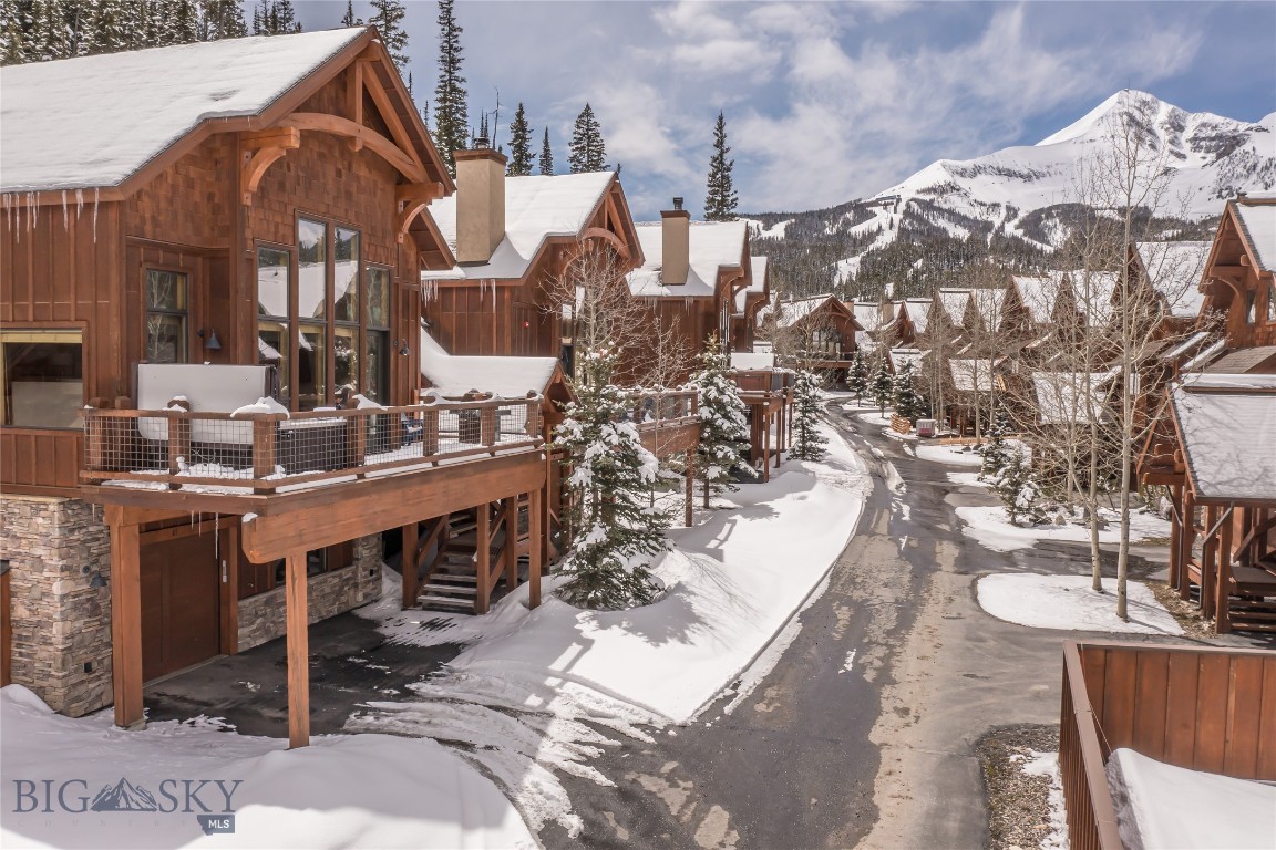 Black Eagle Unit 23 is a stylish, ski-in/ski-out, mountain-modern townhome located just steps from the base of Big Sky Resort in the heart of Mountain Village. Positioned for exceptional ski access by the brand-new Poma lift, this four-bedroom, 4.5-bath residence offers the rare ability to ski directly from the back door to the brand-new Poma lift while enjoying privacy, mountain views, and thoughtful design throughout.

The open main living level is designed for gathering, with expansive windows that fill the space with natural light and access to the deck with stunning Lone Mountain views. Contemporary finishes, warm materials, and a comfortable flow between the kitchen, dining, and living areas create an inviting yet elevated mountain atmosphere. There is even a “game corner” with foosball and a classic arcade video game console. Multiple levels provide excellent separation of space and a second living area on the top floor, making the home equally well suited for personal use or hosting family and guests.

Four well-appointed bedrooms each feature ensuite baths, including a bunk room ideal for flexible sleeping arrangements. After a day on the slopes or trails, the private outdoor hot tub offers a relaxing place to unwind and take in the mountain views. A dedicated mudroom and one-car garage add convenience for all seasons.

The location further elevates the appeal. Black Eagle 23 is within easy walking distance of Big Sky Mountain Village, offering shops, après-ski spots, and a variety of dining options, including M, the seasonal pop-up restaurant by Chicago’s Alinea Group. The residence is also walkable to the Skyline Shuttle, providing convenient access to Big Sky Town Center and Meadow Village year-round. Ski all winter, hike and mountain bike all winter, right from your doorstep!

Combining slopeside access, walkability, and a polished mountain aesthetic, Black Eagle 23 offers a rare opportunity in one of Big Sky’s most desirable resort locations.