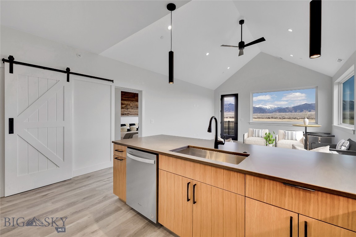 Set against the wide-open landscapes and river corridors that define the Madison Valley, The Drift at North Forty offers a rare opportunity to own new construction in the heart of Ennis. Located within walking distance of Main Street and minutes from the Madison River, these 3-bedroom, 2-bathroom residences provide immediate access to both town and open country. Each home is designed for low-maintenance living with an open-concept layout and expansive windows that frame mountain views and fill the space with natural light. Finishes are durable and clean, designed with a timeless aesthetic that complements the surrounding landscape. The interiors balance practicality and comfort, making the home equally suited for everyday living and extended stays. The walkout primary suite offers privacy and direct outdoor access, while two additional bedrooms allow flexibility for guests, family, or a home office. An attached one-car garage provides protected parking, and the dedicated storage room offers additional flexibility for fly tying, workout equipment, a small home gym, or organized gear storage. Upper-level residences benefit from elevated sightlines and broader valley views. Short-term rentals are permitted, offering owners the option to enjoy the property personally while maintaining income flexibility. World-class fly fishing on the Madison River, hunting and hiking on nearby public lands, and skiing at Big Sky Resort are all within easy reach. Yellowstone National Park and Bozeman Yellowstone International Airport are approximately an hour away, making The Drift at North Forty a well-positioned base for year-round use in the Madison Valley.