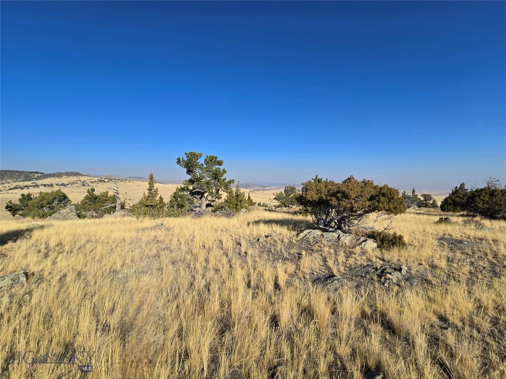 Build your dream home on this stunning 7.607 acre hill top property with gentle slopes. Enjoy breathtaking views of both the Madison Mountain Range and the Tobacco Root Mountains. The Madison River access is nearby.  This is a great parcel has a well in place ready to get started on your Montana Home!  As part of the Shining Mountains community, you'll have exclusive access to Haypress Lakes and vast public lands in the Gravelly Range for outdoor activities such as hiking, horseback riding, ATV adventures, and snowmobiling. The property is just minutes from Varney Bridge and fishing spots on the Madison River, and is only 10 miles from the charming town of Ennis, with its unique shops, restaurants, library, hospital, and schools (grades 1-12). It's also about an hour's drive to both Bozeman and West Yellowstone.