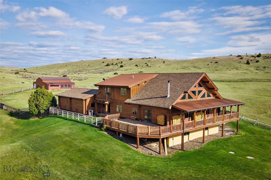 Welcome to your Montana dream log home-where rustic charm meets refined comfort in a true lodge style retreat. Every detail captures the warmth & character of mountain living, creating a space that makes everyday life feel extraordinary. Located in Gallatin River Ranch, this exceptional property offers private access to the renowned Gallatin River. 640 Acres of state land is just a few parcels away, providing even more opportunity for outdoor adventure right outside your door. Gallatin River Ranch is a horse-friendly community & is thoughtfully designed for equestrian living, including an onsite equestrian center. This property includes a shop/equipment shed, a separate loafing shed & is fully fenced & ready for your horses. The open-concept floor plan is ideal for entertaining while remaining perfectly suited for everyday living. On the main level, a spacious living room is anchored by a wood-burning fireplace, a generous dining area for gathering with family and friends, & an open kitchen designed for both function & flow. A convenient wet bar enhances the home's entertaining appeal. You will also find a large mudroom & laundry room-perfect for Montana living-along with two comfortable bedrooms & a well-appointed bathroom. Rich wood finishes, soaring ceilings & spaces, & thoughtful craftsmanship create an atmosphere that feels both grand & cozy. Ascending a timbered log staircase, you'll arrive at the private, expansive primary suite that begins with a welcoming loft-style sitting area. From there, step into the oversized primary bedroom-where a private balcony invites you to take in the breath taking views & fresh Montana air. The en-suite bathroom features a beautifully tiled shower, soaking tub, & dual vanities. Completing the suite is an exceptionally large walk-in closet. Also featuring a walk-out basement, the versatility & space continues. It features two additional bedrooms, a 3/4 bathroom, & a comfortable living room. You will also find an office space, a storage or workshop area for hobbies & projects, & a separate mechanical room. Ideally situated just 25 miles from Bozeman & only 17 miles from Bozeman Yellowstone International Airport, this exceptional property offers the perfect balance of peaceful seclusion & convenient access to dining shopping & recreation. Experience the best of Montana living-where wide-open spaces, breathtaking scenery, & timeless craftsmanship come together to create a place you'll be proud to call home.