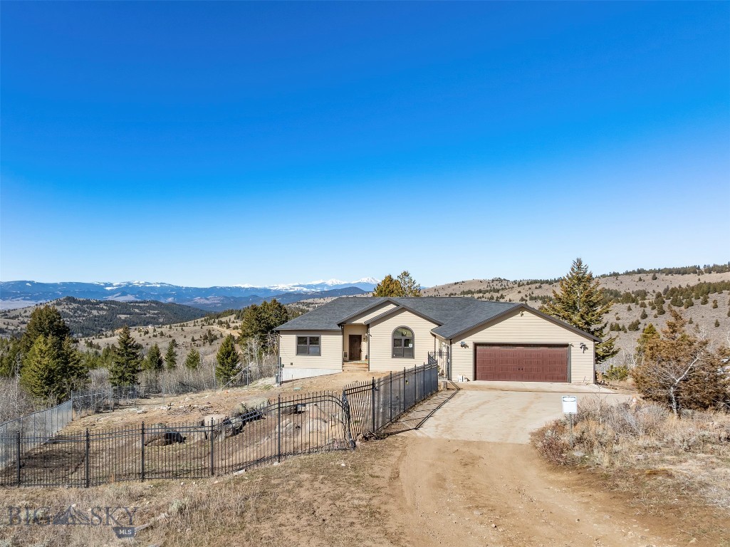 Welcome to 85 Poorman Rd, a stunning custom home built in 2017 offering privacy, space, and breathtaking views in the sought after Moulton Reservoir area. Situated on 13.89+/- acres, this 4,022 square foot home is surrounded by trees and mountains, creating a peaceful setting that truly feels one of a kind.
This spacious home features 4 bedrooms and 3 bathrooms, with the potential to easily convert to a 5 bedroom layout. The main floor offers an open entry, a large living room, a beautiful dining area, and a well appointed kitchen complete with stainless steel appliances, quartz countertops, and a gas stove. You will also find 3 bedrooms on the main level, including a generous primary suite with a private on suite bathroom.

The partially finished basement provides additional space and endless possibilities to customize and add value to fit your needs. Step outside onto the deck and take in the incredible views, including your own private vantage point of the 3rd of July fireworks with the iconic M as your backdrop. This is a rare opportunity to own a custom home with acreage, privacy, and unmatched scenery just minutes from Butte.