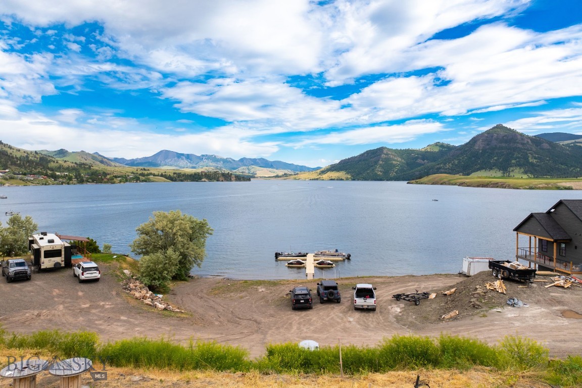 Amazing piece of land at Holter Lake! This rare property with lake access is BUILD READY with over $250,000 of infrastructure completed. Wells completed! Septic systems completed! Electricity to the sites completed! This property features access to docks, boat launch, and a beach. Come and build your dream home with seller financing options available. Call to schedule a tour and ask about these great financing options or your real estate professional. Building in photos is an example of what could be built and is not for sale.