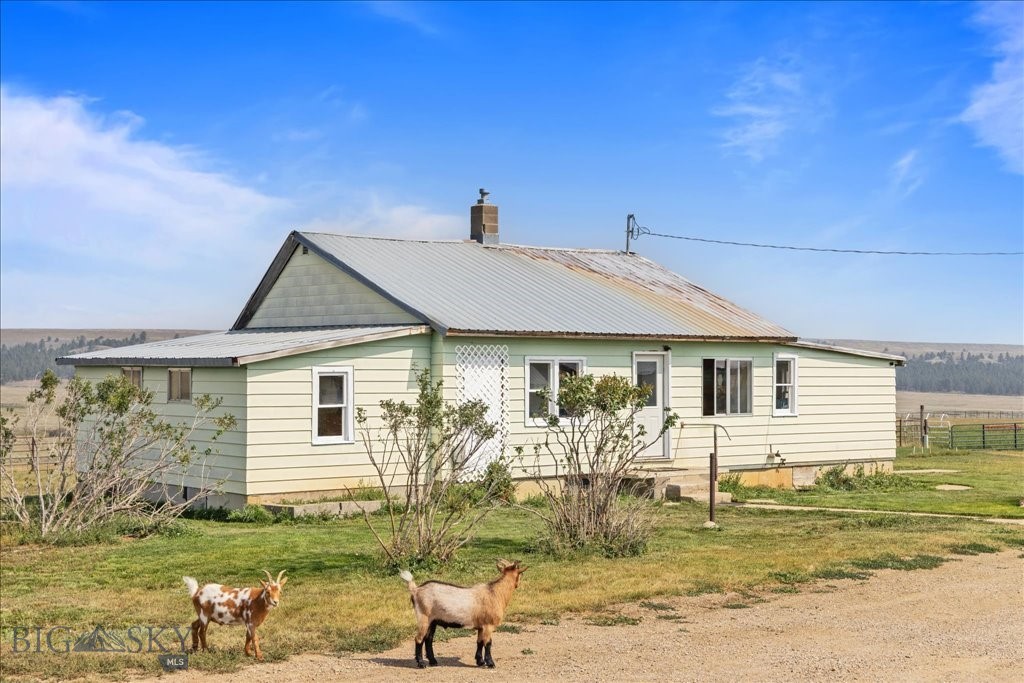 Set on 80 deeded acres just minutes from Lewistown, this picturesque rural property offers the space, privacy, and freedom Montana living is known for. The land is improved with a modest 3-bedroom, 1-bath ranch-style home—ideal as a full-time residence, weekend retreat, or legacy property to enjoy for generations. Well-suited for a variety of uses, the acreage provides ample room for horses, livestock, equipment, or simply wide-open space to roam. Multiple outbuildings enhance the property’s versatility, including a 40x104 shop/barn and a 48x64 barn with a 16x32 tack room addition—perfect for hay storage, hobbies, or an equestrian setup. Over 70,000 sq ft of pipe corrals offer options for both cattle and horses. With sweeping views, quiet surroundings, and convenient access to town amenities, this property strikes a rare balance between seclusion and accessibility. Whether you envision a small horse property, base for a larger ranch operation, a private country homestead, or a place to enjoy the Montana outdoors, this offering delivers opportunity, functionality, and the timeless appeal of Central Montana living. Can be purchased with an additional 200 acres and 320 acre BLM grazing allotment for $1,500,000. (MLS# 405650).