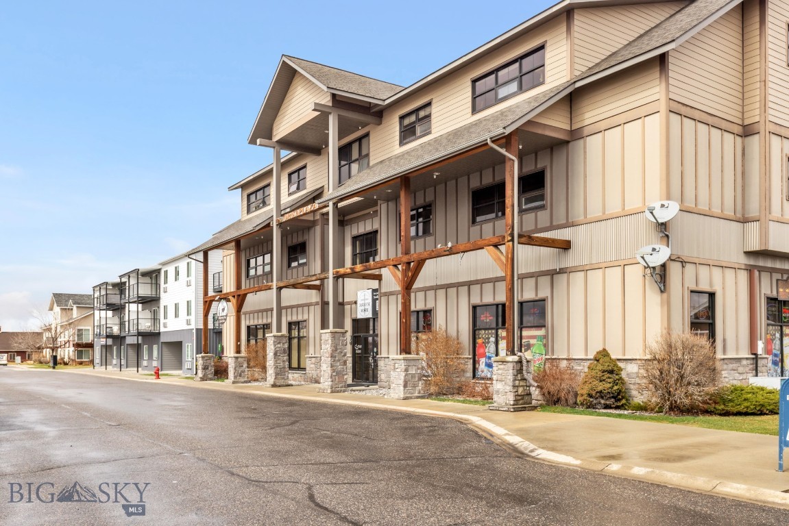This fully furnished studio condo offers a bright, functional space with thoughtful design and low-maintenance living. Located in a secure building beside a quiet pond, it features wood floors, industrial-style finishes, and abundant natural light. A washer and dryer are included for added convenience. The building provides everyday ease with an elevator, on-site grocery store, and a gym just outside the door. Enjoy nearby walking paths and easy access to I-90, the airport, and Bozeman. Ideal for first-time buyers, students, or those seeking a lock-and-leave property—with investment potential and a history of short-term rentals.