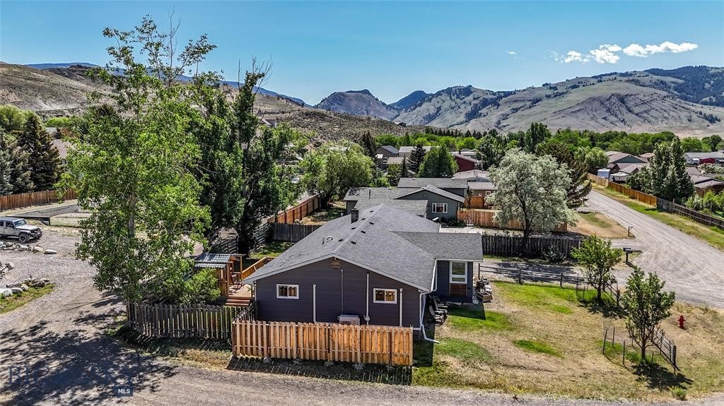 Welcome to your Montana retreat in the heart of Gardiner, just minutes from the North Entrance of Yellowstone National Park. Tucked away on a quiet street yet close to downtown, this beautifully updated 3 bedroom, 2 bath home with two additional bonus rooms offers the ideal blend of comfort, flexibility, and income-producing potential as a successful VRBO getaway. Designed for both everyday living and guest enjoyment, the bright, open main level features durable luxury vinyl plank flooring and a spacious kitchen that flows effortlessly into the living and dining areas, perfect for gathering after a day of adventure. Step outside to the expansive deck and take in scenic mountain views and star-filled Montana skies from the hot tub, or unwind in the sauna after exploring Yellowstone. Comfort comes year round with baseboard heat, a cozy pellet stove, and a brand-new energy efficient 4 zone mini-split heat pump system serving the main level rooms. The two lower level bonus rooms provide versatility for additional accommodations, home office space, recreation rooms, or future expansion opportunities. Located within walking distance to Gardiner’s restaurants, shops, parks, and schools, and less than a mile from Yellowstone’s iconic North Entrance, this turnkey property offers rare convenience for both homeowners and vacation guests seeking immediate access to hiking, fishing, wildlife viewing, rafting, and endless outdoor recreation. Whether you’re searching for a full time residence, vacation home, or short term rental investment, this move in ready Gardiner property delivers lifestyle, location, and opportunity.