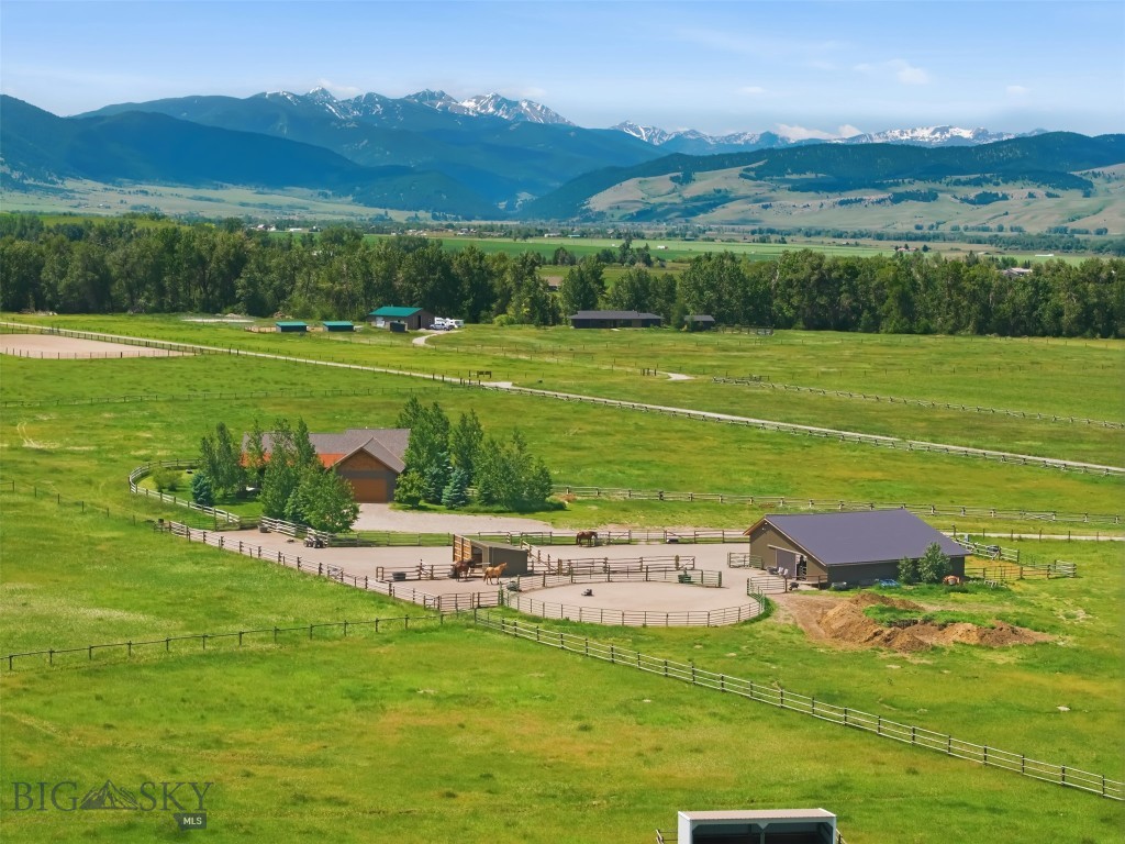Montana luxury meets timeless Western living at this exceptional 20.21-acre horse property in Gallatin Gateway. Built in 2017, this beautifully crafted 3-bedroom, 2.5-bath residence offers 1,785 square feet of thoughtfully designed living space, combining high-end finishes, stunning mountain views, and equestrian amenities in one remarkable setting. Inside, rich hardwood floors, custom cabinetry, and quality craftsmanship create a warm and inviting atmosphere. The chef-inspired kitchen features a Viking gas cooktop, double ovens, custom countertops, and ample workspace for entertaining or everyday living. Expansive floor-to-ceiling windows capture breathtaking views of the Spanish Peaks and Bridger Mountains, filling the home with natural light and showcasing Montana's ever-changing landscape. You'll love enjoying the wrap around covered deck, especially in the summer for grilling and just relaxing, entertaining, or watching the storms rolling and out. The hot tub off the primary suite is private and the perfect start and end of any day! Designed for horse enthusiasts, the property includes a 48' x 48' four-stall barn with generous hay storage, a separate run-in shed, round pen, corrals, and fenced and cross-fenced pastures with classic jack-leg fencing. Seasonal live water and valuable water rights further enhance the usability and appeal of this exceptional acreage and the home is equipped with AC. Ideally located in the heart of Gallatin Gateway, this property offers the perfect balance of privacy and convenience, with easy access to world-class fly fishing, endless recreational opportunities, Big Sky Resort, and Bridger Bowl.  Whether you're seeking a full-time residence, equestrian retreat, or Montana getaway, this one-of-a-kind property delivers the lifestyle you've been dreaming of. One seller is a licensed Montana Real Estate agent.