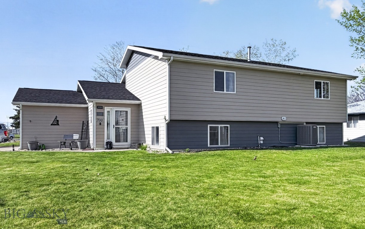 Welcome to 700 Mayfair in Belgrade, Montana — a spacious and inviting five-bedroom, three-bathroom home designed for comfortable living and entertaining. Situated on a desirable corner lot across from a community park and baseball fields, this property offers the perfect blend of space, functionality, and location.

The main level features an open dining area with access to a beautifully updated second-story deck overlooking the fully fenced and landscaped backyard, complete with mature trees, underground sprinklers, and recent landscaping improvements — an ideal setting for relaxing and enjoying Montana summers. Inside, you’ll appreciate numerous thoughtful upgrades throughout the home, including updated kitchen cabinets, countertops, appliances, upstairs flooring, interior paint, and refreshed primary bedroom closet doors. Additional improvements include newer upstairs windows, including the sliding glass door and kitchen window, plus updated fencing in the front section of the backyard.

The fully finished basement provides additional living space with three bedrooms, a cozy gas fireplace, walk-in storage closets, and an oversized laundry room. An oversized two-car garage includes a built-in workbench and abundant storage space for tools, outdoor gear, and toys.

Major updates such as the roof and AC unit provide added peace of mind, making this home truly move-in ready. Conveniently located just minutes from all Belgrade public schools, this one-of-a-kind property offers space, comfort, and an unbeatable neighborhood setting.