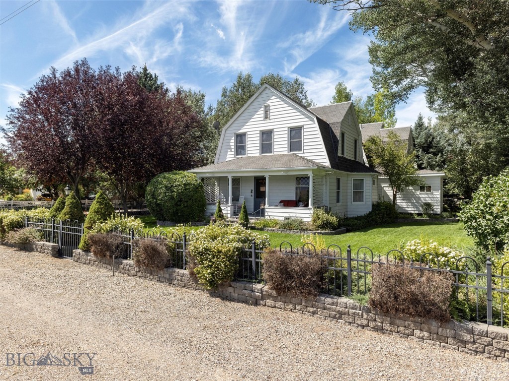 Nestled in the quiet little hamlet of Jeffers, MT, w/ stunning views of the majestic Madison Range, this stately historic landmark residence is one of the original Jeffers family homes, located only 1.5 mi from Ennis, MT. Built in 1900 & restored to capture the look of Montana’s Gilded Age. The main home offers 2 primary suites & has a total of 5 BR & 5 BA. The main house can comfortably sleep 10 people. The 1st floor includes a large owners suite, beautifully furnished with antiques from around the world, a full ensuite bathroom including a jetted tub, fully tiled shower & large walk-in closet. There is a formal dining room, living room, library, utility room & foyer entrance. Also featured on the 1st floor is a newly renovated stainless steel, quarts counter-top kitchen that is the final modern touch that makes this residence truly stand out. The 2nd floor of this home has the 2nd owner’s suite that includes its own private terrace, a large full bath, office space & TV sitting area. There are 3 additional bedrooms & a hallway bath that completes the 2nd floor. Additionally, there are linen & housekeeping closets. Finished in 2022 is The Bear's Den, a 750SF cottage hidden just across the bridge, landscaped backyard. This cute little cottage has a great room w/ 14-foot ceilings. There is a kitchen, king-size bedroom & a 3/4-bathroom w/ a walk-in closet. There is a private stone patio area with a water feature, seating & BBQ. This cottage & its patio are barely visible from the main house. Very private & quiet, perfect as a small rental or great as an owner's residence when the main house is being used as short or long-term rental. Attached to the cottage, is a covered RV parking area w/ a separate shop & storage enclosure. The property also offers a 90SF detached 2 car garage w/ automatic door openers. The garage has 2 fridges, 1 freezer & a dry or canned goods pantry. Also in the garage is a lockable, walk-in closet. The highlight of the garage is the comfortable studio & bedroom attached on the western side of the garage that measures 240SF. It’s the perfect private space to work with power & Wi-Fi. Because of its great Micro-Climate this property offers beautiful outdoor living spaces. A large Roman Stone Patio has a BBQ, casual seating & dining areas. There are perennial flower gardens, 3 water features, towering shade trees, lush lawns & mature landscaping.  Cedar Creek flows seasonally through the property lending its gently ambiance.