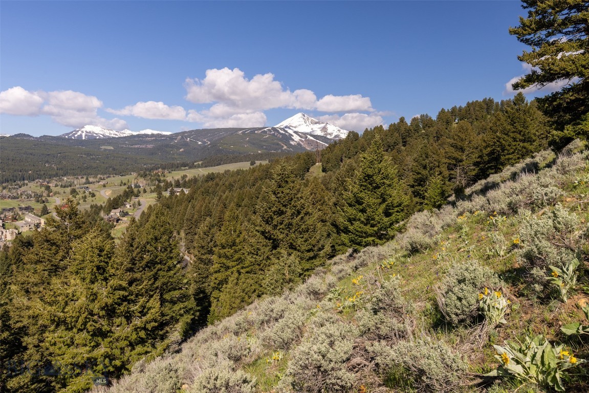 Back on the Market at a Reduced Price of $499,000.

Perched on 2.08 private acres at the end of the Two Gun White Calf cul-de-sac, this exceptional homesite offers a rare combination of privacy, views, and convenience in the heart of Big Sky. This sloped, moderately treed terrain creates a beautiful natural setting while providing flexibility for a thoughtfully designed mountain home.
From its elevated position, the property captures sweeping south-facing views across Big Sky's Meadow Village, with abundant sunshine and stunning vistas throughout the year. Tucked away from through traffic, the cul-de-sac location offers a peaceful retreat surrounded by nature.

Despite its secluded feel, the property is just minutes from the amenities that make Big Sky such a sought-after destination. The Meadow Village golf course, post office, restaurants, shopping, and Big Sky Town Center are all within a five-minute drive, while world-class skiing and mountain recreation at Big Sky Resort are only 15 minutes away.

Now offered at $499,000, this is an outstanding opportunity to secure a premier homesite with expansive views, privacy, and easy access to everything Big Sky has to offer.