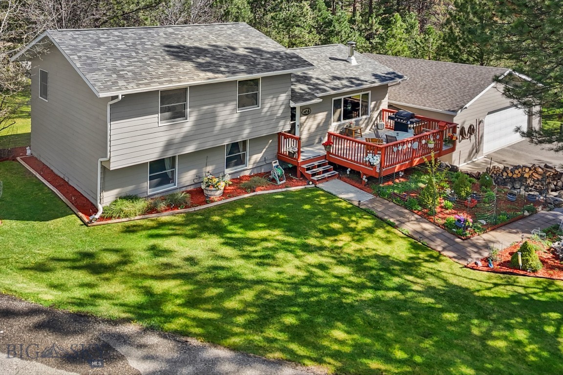 Tucked into the pines of Blue Sky Heights in Clancy, this home has the kind of character that's impossible to replicate. Three bedrooms, two bathrooms, two living spaces, and a layout that actually works for real life.
The main level living room is warm and welcoming — hardwood floors, big windows framing the trees, and a wood-burning stove that makes Montana winters something to look forward to. Head downstairs and you've got a second family room anchored by a gas stove and enough space for everyone to spread out. Two living spaces that each have their own personality.
The primary suite features a tile jacuzzi tub, double vanity, and a separate shower. Outside, the mature landscaping has been lovingly tended for years — towering trees, rock accents, a generous deck, underground sprinkler system, a treehouse, and an oversized three-car garage that is heated and insulated. And if that's not enough peace of mind: brand new roof installed this spring, and the home is connected to a whole house generator back-up system. 
Blue Sky Heights is one of the most coveted pockets in Clancy. This home shows what it means to truly take care of a place. Come see it in person.