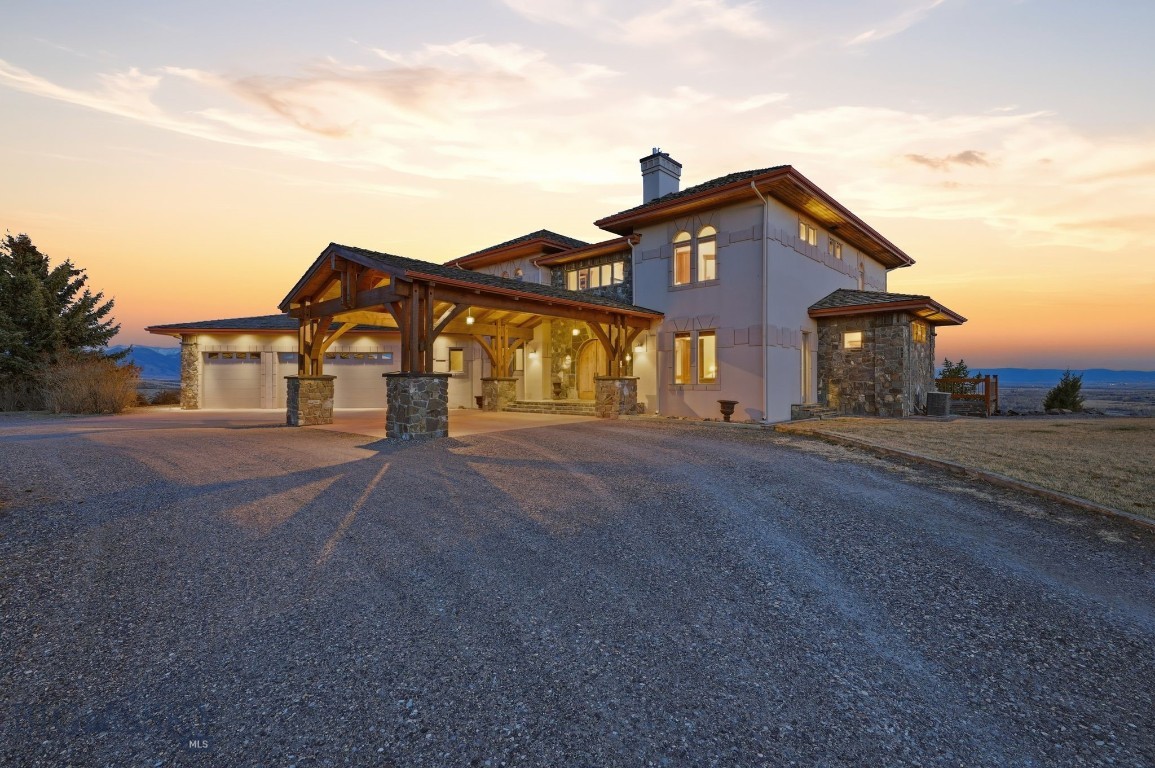 Perched above the Gallatin River with commanding, unobstructed views stretching across the valley, this is one of the most exceptional homesites in the Bozeman area. 
From the moment you enter the stone clad with timber pillars, the 20.5 acre property reveals its striking design, featuring a dramatic open-air concept between levels that creates a seamless flow of space & light. Expansive windows frame the river & mountains like art, filling the home with natural light & protected views. 
Designed for both entertaining & everyday comfort, the 6,537 SF home features 6 spacious bedrooms, 6 bathrooms, a chef’s kitchen, a private library, an executive office, fully equipped theater room & lower level kitchen with wine cellar. 
Every floor has bedrooms, with the primary en suite on the upper level complete with its own fireplace & breathtaking views. This creates a private sanctuary within the home. Spacious bedroom on main floor could easily be converted to an additional primary en suite. 
The chef’s kitchen opens seamlessly to the fireplace-centered living room, creating an ideal setting for gathering & entertaining. From there, step into an exceptional outdoor living space designed to capture sweeping river & mountain views, complete with a statement outdoor fireplace & a premium vented BBQ. 
The property continues to impress with an outdoor pond & a beautifully designed 1,272 SF guest house, offering the same level of quality and attention to detail. It features a spacious kitchen,  2 beds, 2 baths, a/c  & its own fireplace. Ideal for hosting guests, a care taker or accommodating multigenerational living in comfort and style. 
A massive 3,600 SF shop/barn provides exceptional versatility, featuring five stalls, pass-through access, hay storage, an RV-height garage door & extensive space for equipment, recreational vehicles, or hobbies. 
As part of GRR, ownership includes access to: walk-out Gallatin River frontage (3 min. from this home), 640 acres of State Land & 270 acres of Fish & Wildlife land. A privately owned world-class equestrian center within the ranch offers boarding, training, and both indoor & outdoor arenas. 
Enjoy miles of riding trails, blue-ribbon fly fishing & the quiet beauty of Montana living—all just 25 minutes from Bozeman, with convenient access to Yellowstone International Airport & recreation in Big Sky. 
A rare opportunity to own a legacy estate with top of the world views. Call your favorite realtor for a private showing.