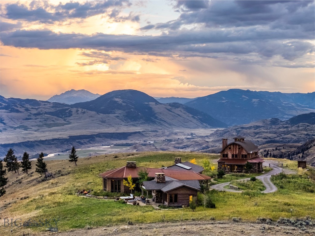 Paradise found in Paradise Valley. The New Moon Lodge is a spectacular home & guest house strategically perched high above the valley floor, offering breathtaking views of the Absaroka mountains. Situated on 21.37 acres and bordering public land, Yellowstone National Park is less than an hour away, world class fly fishing on Yellowstone River is just down the hill, and endless hiking, camping, and hunting opportunities abound. For those seeking unique Montana culture, historic and artistic Livingston is 30 minutes away, while the thriving college town of Bozeman is an hour.
The Main Lodge features vaulted ceilings with massive stone fireplaces, exposed reclaimed timbers, hardwood floors, and custom finishes & woodworking throughout. Large picture windows capture the views of the mountains, valley floor and Yelllowstone River. Entertaining is a breeze with two large dining tables, a full sized saloon-style western bar, and spectacular chef’s kitchen that boasts an oversized island, double dishwashers, double gas range, and sub-zero refrigerator and freezer.
The master suite is a very private wing of the main level that features a rock fireplace, spacious bathroom with walk-in shower, office space, screened in sleeping porch, exterior hot tub and outdoor fire pit. 
Also the ground level of the main lodge are 2 additional bedrooms, each with a private bath, and another cozy living area with a fireplace and ample seating. 
The downstairs has a game room with theater projector screen and a full-size billiard pool table. 
Next to the main Lodge is the Barn Bunk House, which, at 3,307 SF, is really an expansive second home. The ground level has an enormous laundry room with 3 washers & dryers, dog wash area, and oversized 2 car garage. On the upper level you'll find a kitchenette, loft, and 2 large bunk room-style bedrooms with attached baths and doors to the exterior balcony. 
The landscaping outside the lodge is equally awe inspiring with massive rock fireplaces, rock patios and walkways, mature pines and aspens, and of course, more exquisite views of the mountains.
The property has lots of flexibility and would make a perfect setting for corporate retreats, family gatherings, high end vacation rental that can sleep 20, or as your own mountain getaway. The New Moon Lodge is being sold furnished and is ready to host your next great adventure.