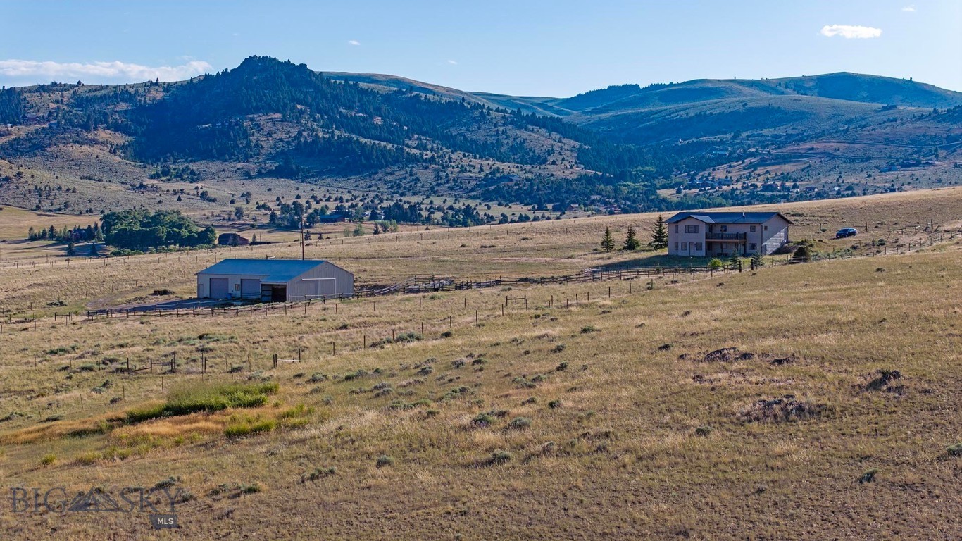 Set on 20± pristine acres, this exceptional property captures the essence of Montana living with sweeping mountain vistas, abundant wildlife, and a serene, private setting. Ideally located near world-class hunting and blue-ribbon fishing, adventure awaits just minutes from your doorstep. The charming town of Ennis, renowned for its fly-fishing culture offers convenient access to dining, shopping, and amenities. The property is thoughtfully improved with a 2,944± square foot, three-bedroom, two-bathroom residence, complemented by a spacious 40' x 64' shop featuring a tack room and ample equipment storage perfectly suited for equestrian pursuits or recreational use.