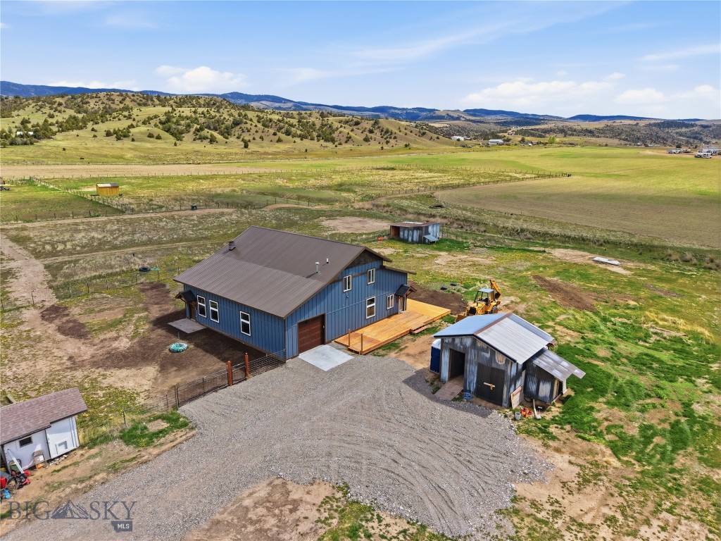 Fully renovated 3 bedroom, 3 bath home offering 2,700+ sq ft on 10 acres that is TURN KEY!! This thoughtfully designed floor plan features a spacious living room that flows seamlessly into the large open dining area, creating an inviting space for entertaining and can fit oversized furniture pieces. Expansive windows flood the home with natural light, giving the main living areas a bright and airy feel. The stunning kitchen is completely move-in ready with stainless steel Samsung appliances, gas range, Quartz countertops, floor to ceiling cabinetry with contemporary finishes, and a beautiful modern aesthetic. A versatile designer feature wall with floor to ceiling tile creates the perfect space for a coffee bar, beverage station, or secondary prep area. The waterfall peninsula adds both style and function, with seating for two bar stools. Conveniently located on the main level, the primary suite features a beautifully renovated ensuite bath with dual vanities, a tiled walk-in shower with glass doors, and a separate toilet room. Upstairs, you'll find a second living area ideal for a media room, playroom, or guest retreat, along with two additional bedrooms connected by a Jack-and-Jill 3/4 bath. An extensive built-in cabinet shelving in the guest bathroom provides exceptional storage. The laundry room has hook-ups available for a washer and dryer, and the space could also be transformed into an incredible walk-in pantry or additional storage area. The extensive list of recent upgrades is top to bottom of this home and includes but not limited to, new flooring, a fully remodeled kitchen, new appliances, majority new windows, new electric baseboard heat, brand new upstairs guest bath and master bathroom, and new outdoor wood wraparound decking. An attached heated 1-car garage adds year-round convenience. This property truly feels like a brand-new home. Northwestern Energy service was fully routed to the home and installed in April 2026.  A rare opportunity to enjoy a modern home with country living, flexibility, and endless possibilities.