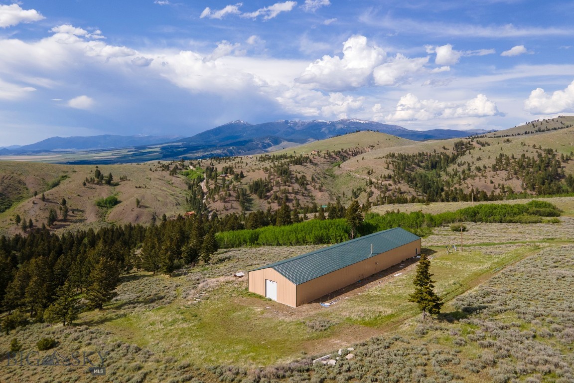Experience the freedom of Montana living on this exceptional 20.185± acre horse property in beautiful Townsend, Montana, with endless possibilities. Designed with both functionality and flexibility in mind, the property centers around an impressive 10,000 square foot heated shop measuring 50’ x 200’, featuring 16-foot walls, two 12’ x 14’ automatic roll-up doors, a well, power, a 2,500-gallon water storage tank, and a central wood boiler system (Classic Edge 760).

This versatile space offers incredible potential for an indoor riding arena, fabrication shop, equipment storage, or even a custom live/work conversion. Bring your horses, recreational toys, business ideas, or all of the above.

The setting is equally remarkable. Take in breathtaking 360-degree views of the Elkhorn Mountains, Big Belt and Little Belt ranges, Canyon Ferry Reservoir, and the picturesque Townsend Valley below. A seasonal creek winds through the property, attracting abundant wildlife and adding to the peaceful Montana atmosphere. Mature trees and shrubs accent the open pastureland, providing excellent grazing and room to roam for animals and outdoor enthusiasts alike.

If you’ve been searching for wide-open spaces, incredible views, and a property with unmatched versatility, this Montana gem is ready to deliver.