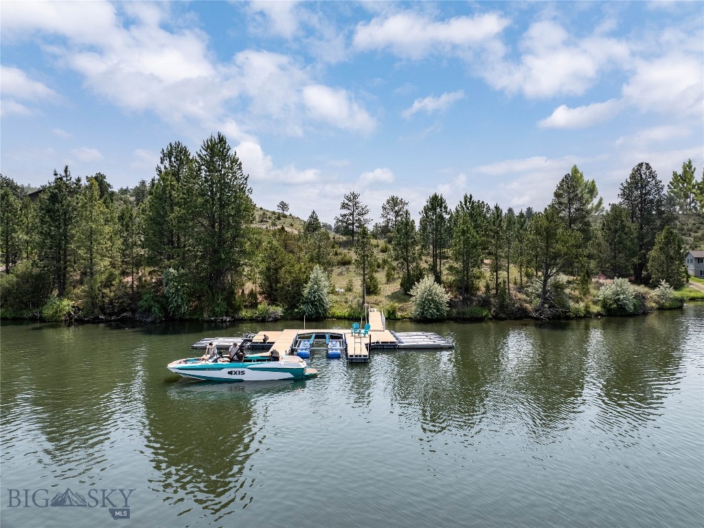 Rare opportunity to own 12.09 acres on Danas Point with direct frontage on Hauser Lake, offering an exceptional setting for a future Montana lake retreat. Power is already installed on the property, and an incredible ShoreMaster dock system is already in place, featuring a large boat lift, ride on slips for personal watercraft, and a private gravel boat launch for effortless days on the water. Expansive lake views, rolling terrain, and a unique peninsula style setting create a remarkable sense of privacy, space, and connection to the surrounding landscape.

Located less than one tenth of a mile from over 600 acres of State Land, the property is surrounded by the recreation and natural beauty that define Montana living. The property is approved for one single family residence, offering an outstanding opportunity to create a custom home or seasonal retreat designed around panoramic lake views, with ample space for outdoor living, entertaining, and enjoying the waterfront lifestyle. Whether your days are spent boating, paddle-boarding, fishing, or simply relaxing by the water, this property provides the ideal backdrop for making the most of every season.

The propertys ownership extends beyond the shoreline into Hauser Lake, creating a distinctive waterfront offering that complements the existing private dock system and boat launch while enhancing its direct connection to the lake. Of the total 12.09 acres, approximately 9 acres extend below the water line, leaving roughly 3 acres of upland for the approved homesite while providing a unique waterfront ownership configuration. Opportunities to own a parcel with this combination of privacy, established lake access, and proximity to public recreation are increasingly rare.
