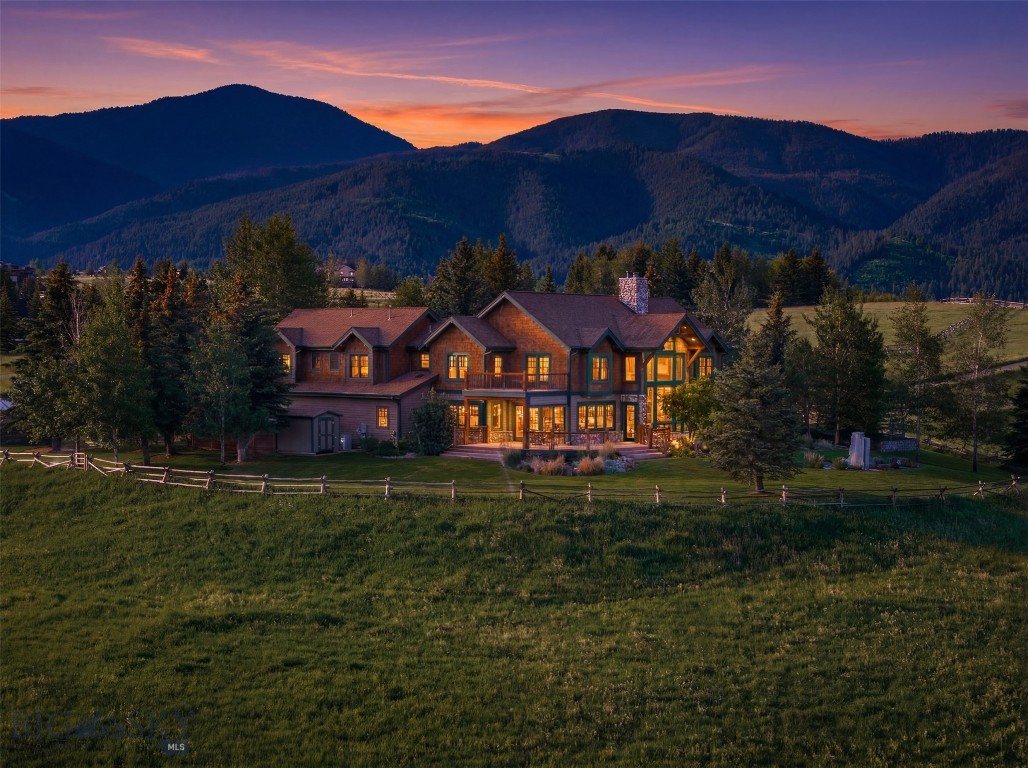 Hidden atop one of South Bozeman’s most coveted ridgelines, 390 Hayrake Lane offers an extraordinary blend of luxury, privacy, and panoramic Montana beauty. Encompassing over 5,200 square feet of peacefully designed living space, this five-bedroom, five-and-a-half-bath home captures jaw-dropping views of the Tobacco Root Mountains, Bridger mountains, surrounding farmland and a vast majority of the city of Bozeman.

Positioned on a fully fenced property with wide-open privacy, the setting evokes the feeling of a private Montana retreat while remaining just minutes from downtown Bozeman, Bozeman Health Deaconess Hospital and everyday conveniences.

The home’s striking architecture is highlighted by soaring vaulted ceilings, floor-to-ceiling west-facing windows, and an impressive stone fireplace anchoring the incredible great room. Warm rustic hardwood flooring flows throughout the main level, complementing the home’s timeless mountain-modern character. Fresh interior paint and a whole-house saltless water softening system provide immediate comfort and peace of mind.

Designed for both everyday living and entertaining, the spacious kitchen serves as the heartbeat of the home, featuring generous counter space, quality finishes, and seamless connectivity to the dining and gathering areas. One of a kind custom reclaimed wood mudroom with built-in bench seating, storage, coat organization and laundry room.

The upper level offers a substantial bonus and recreation space complete with a wet bar, billiards area, four bedrooms, and media lounge—an ideal setting for entertaining guests, hosting game nights or enjoying family movie nights; all with the backdrop of Bozeman's iconic "M" trail in the distance.

390 Hayrake's outdoor living is equally impressive. A beautiful stone fountain that creates a tranquil focal point while the home’s elevated position showcases some of the most spectacular sunsets and western views available in the Gallatin Valley. The year round incredible green house is most certainly worth writing home about. 

Adding tremendous versatility and value, the property’s barn has been transformed into an exceptional high-end shop, creating endless possibilities for hobbies, equipment storage, workshop space, recreational vehicles, or future equestrian use. 

Rarely does an opportunity come around to own a property that so perfectly combines luxury, privacy, practicality, and commanding views in Bozeman's most sought after location!
