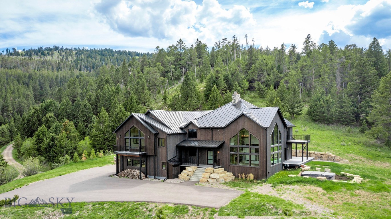 Experience the Feeling of Coming Home to Your Own Private Montana Mountain Retreat at 280 High Ridge Road. This Extraordinary Custom Residence Offers Over 5,900± Sq ft of Refined Mountain Living, a True Sanctuary Where Privacy, Comfort & Natural Beauty Come Together.
From the Moment You Arrive, There Is an Undeniable Sense of Calm. Wake Each Morning to Sweeping Mountain Vistas, Breathe in the Fresh Alpine Air & Enjoy the Peaceful Stillness of Nature From a Home Designed to Make Everyday Life Feel Both Grounded & Inspired. Whether You Are Watching the Seasons Change Through Walls of Glass, Gathering Around the Dramatic Stone Fireplace, or Unwinding Beneath the Open Montana Sky, This is a Place That Invites You to Slow Down, Reconnect & Truly Savor Where You Live.
At The Heart of the Home, the Chef’s Kitchen is Both Beautiful & Welcoming, Featuring Custom Cabinetry, Premium Appliances & a Seamless Layout Designed for Effortless Entertaining. Indoor & Outdoor Surround Sound Speakers Create the Perfect Atmosphere, Whether Hosting Memorable Gatherings or Enjoying Quiet Evenings at Home.
Designed For Both Everyday Comfort & Grand Entertaining, The Home Offers Two Private Bedroom Suites, Dual Offices for Work or Creative Pursuits, a Stunning Great Room with Vaulted Ceilings, Floor-To-Ceiling Windows & a Commanding Stone Fireplace That Fills the Space with Warmth, Character & a Sense of Montana Grandeur. Every Room Was Thoughtfully Designed to Capture the Surrounding Landscape, Drawing the Outdoors In & Reminding You Daily of The Beauty Just Beyond Your Door.
Step Outside & Embrace Montana Living at Its Finest. A Year-Round Bullfrog Swim Series Spa Is Perfectly Positioned to Take in Panoramic Views Through Every Season. For Added Comfort & Confidence, the Property Includes Impressive Off-Grid Capabilities with Solar Power, a Battery Backup System & a Generac Generator—Offering Peace of Mind in Every Season.
The Expansive Five-Car Garage Provides Abundant Room for Vehicles, Outdoor Gear & Every Montana Adventure Toy Imaginable
280 High Ridge Road is More Than a Home—It is a Feeling. A Feeling of Privacy, Peace, Freedom & Connection to the Montana Landscape. It is the Quintessential Montana Experience, Where Mountain Majesty, Modern Comfort & Everyday Serenity Come Together in Unforgettable Fashion.
