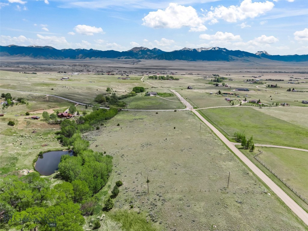 Discover the perfect blend of privacy, convenience, and Montana beauty on this 6.596± acre parcel in Virginia City Ranches. Located just off the blacktop on Noack Road, this property offers year round access, power on the lot, and a well already in place making it truly ready for your Montana dream home. The land features a beautiful mix of trees for natural privacy, with water features including a small portion of a pond and 8 Mile Creek (there are no water rights to either) along the northwest boundary, adding both character and functionality. Take in sweeping views of the Madison Mountain Range and enjoy big Montana skies in every direction. Ideally situated just outside of Ennis, about an hour from Bozeman, and within easy reach of West Yellowstone, you’ll have convenient access to dining, shopping, and amenities while still enjoying peaceful rural living. Outdoor recreation abounds with world class fly fishing on the Madison River, hiking, hunting, horseback riding, off roading, and winter sports are all nearby. Yellowstone National Park is just a scenic drive away. If you’re looking for acreage with personality, water features, infrastructure in place, and unbeatable access, this Virginia City Ranches property is ready to bring your vision to life.