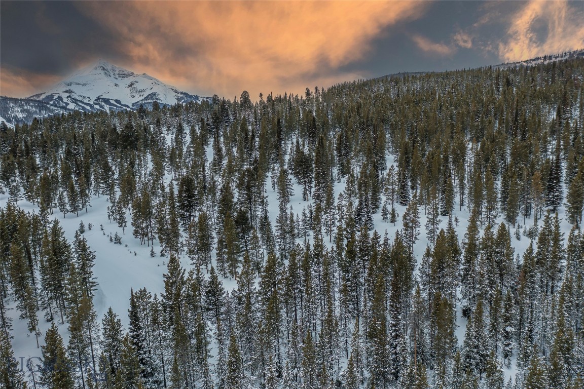 This stunning 20-acre homesite is tucked within the coveted Lost Trails Retreat subdivision conveniently located between Town Center and Big Sky Resort. With its gently sloping terrain and breathtaking views of the surrounding mountains, this property is the perfect canvas for your custom-built home or vacation getaway and offers endless possibilities for a mountain retreat. Montana is becoming a favorite for those seeking a peaceful escape from the hustle and bustle of city life. When looking at where to base your year-round outdoor adventures in one of the country's most stunning natural settings, this property is sure to meet all your needs. From hiking, fishing and biking to alpine and XC skiing, the Big Sky area offers a wealth of recreational opportunities that delight outdoor enthusiasts of all ages. With Big Sky's charming shops and restaurants, and exciting events like Wildlands Music Festival, Big Sky Skijoring, weekly farmers' markets and free concerts just a short drive away, life in Lost Trails Retreat allows you to enjoy the perfect blend of seclusion and convenience.
