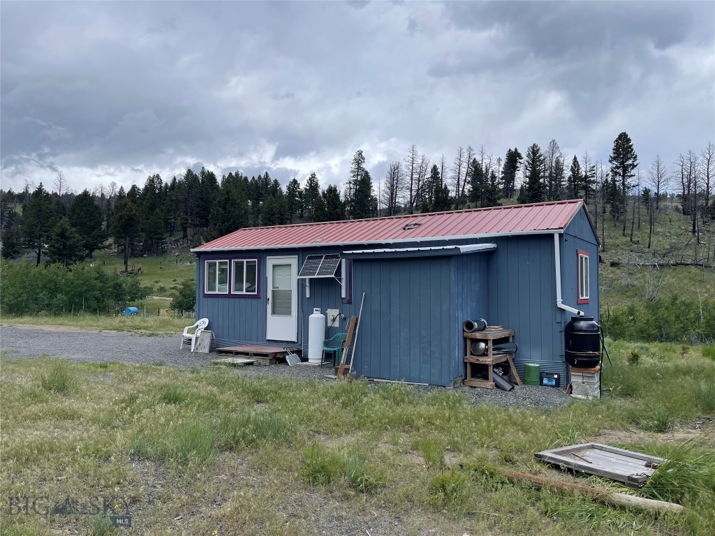 Looking for your Montana retreat??? Lush green grass, wildflowers, wildlife, and spectacular views of the Tobacco Root mountains is what this gem has to offer. Listen to the year round creek that meanders through this beautiful 18 acres of land. A 1 bed cabin has already been built but just in need of a little finish work. There is an established garden area that is irrigated by a solar powered pump. Several more building sites including one that has a concrete foundation with plumbing in place, septic has been permitted and ready to install. Multiple outbuildings, a shooting range, and some building materials are included in the sale. Property has been used as “Off Grid” but power is within close proximity!