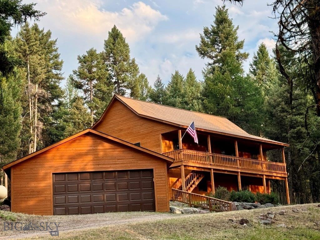 Immaculate custom home with room to roam. 3 BR, 2 BA 2,656 total square feet - 2,018 sq. ft. is finished plus 638 sq. ft. in lower level that could be easily finished off for additional living space or hobby/ shop area. This very comfortable home features a home office/ workspace, large family room with a free standing propane stove for winter warmth and ambiance. The main level features an open floor plan with vaulted pine ceilings, kitchen with oak cabinets and tile flooring, gas cook stove, laundry, and a primary bedroom with walk in closet, plus 2 additional guest bedrooms and full bath. The home has large, covered decks that you can enjoy year-round. The 2-car garage is equipped with freshly coated floors and automatic opener, nice yard area, and is wired for a backup generator. Situated on 2.04 acres with a nice mix of pine trees, some of which may be cleared to enhance mountain views to the west. Relax on the covered patio and enjoy the serene forest views. Seeley Lake public boat access and the Double Arrow 18-hole golf course are only a 15-minute drive.