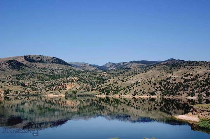 BLUE WATER RANCH: UNEQUALED-TOTALLY UNIQUE RANCH! That’s our opinion, and we believe you will enthusiastically agree!   UNEQUALED-TOTALLY UNIQUE RANCH! That’s our opinion, and we believe you will enthusiastically agree!   Where else could a discriminating owner shelter wealth in an uncertain world environment, and simultaneously enjoy approximately 1.16 +/- miles of lake frontage on the deep, blue, rainbow trout filled waters of Ruby River Reservoir--coves, beaches, rocky cliffs, and two warm spring ponds and potential for more ponds, reservoirs and water features. Impressive rock formations, grazing pastures, rolling and rugged hillsides with juniper and pine, as well as truly stunning views of five mountain ranges: The Rubies, Upper Rubies, Snow Crest, Tobacco Root, and Greenhorn ranges. There are many excellent building sites, including one of the finest locations in southwest Montana.  The Ranch is comprised of 380.83 acres, and bounds an additional 330 acres of BLM--wild, otherwise difficult to access, tree filled hillsides and rugged canyons teeming with wildlife.
