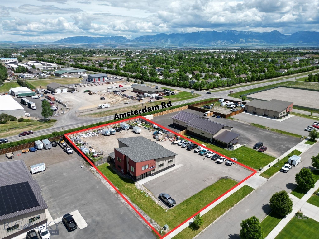 Desirable commercial building located on almost 1 acre lot offers additional area in the rear for storage or expansion. Centrally located with direct access to Belgrade traffic frontage and easy commute to Bozeman or connections to interstate, it is an ideal location for the Gallatin Valley. Building features a combination of office space and enclosed oversized garages. Three 14 foot overhead automatic doors with 16 foot warehouse ceilings provide ample space. Main floor entry reception area with office, kitchen and full bathroom with shower. Upstairs is another office and a large conference room with vaulted ceilings.