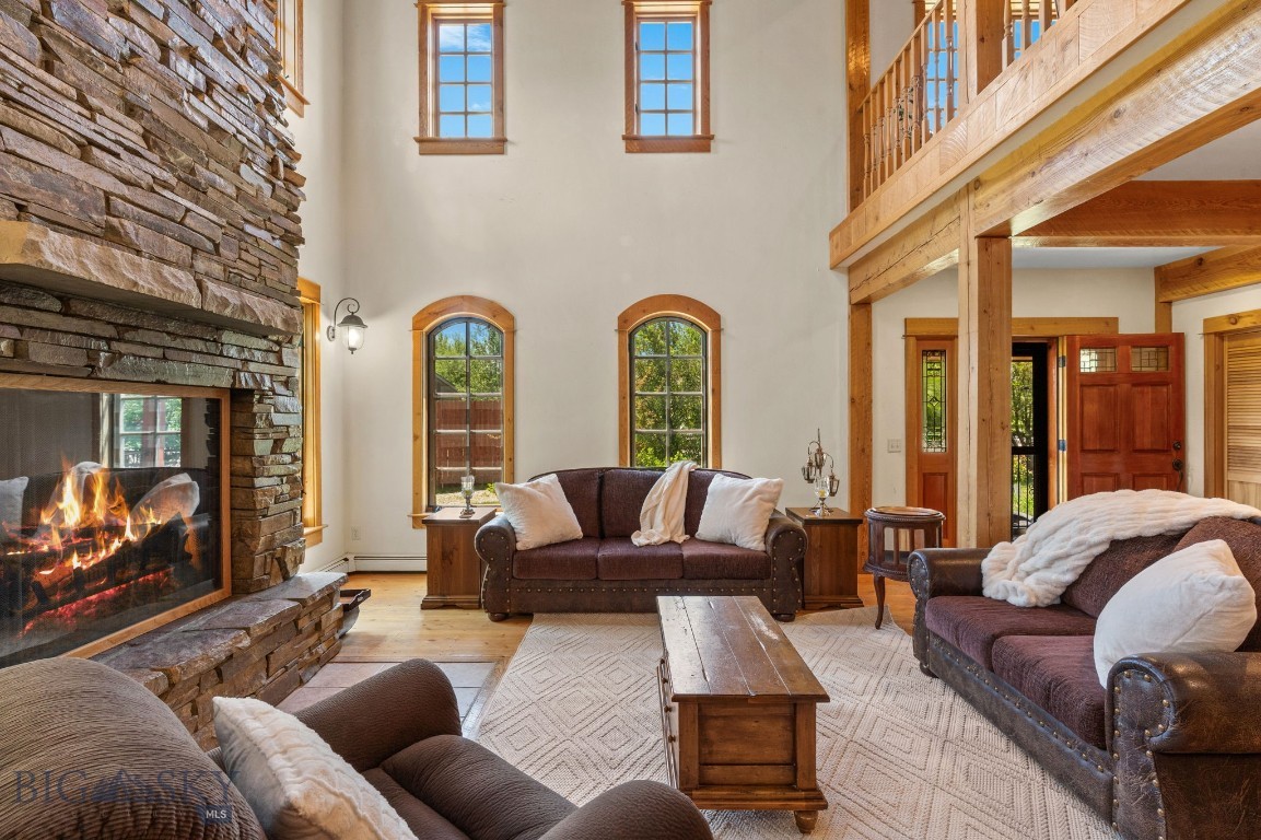 This beautiful 4,600+ sq ft custom home is on a spectacular .56 acre lot at the end of the cul de sac in the desirable Ramshorn View subdivision less than a mile south of the Big Sky turnoff. As you enter this gorgeous home, the focal point is a stunning, stacked rock wood burning fireplace towering over 20 feet high. With extensive beam work from old growth douglas firs and circle sawn doug fir hardwood floors and solid wood Sierra Pacific window package, the craftmanship and attention to detail is abundant. The expansive floorplan has great spaces for entertaining and offers lots of flexiblity. On the main level, in addition to the stunning living room with towering ceilings, there is a spacious dining room adjacent to the large kitchen with pantry. Down the hall there is an ensuite bedroom, laundry, mudroom and 1/2 bath. The main level also features a large family room/game room and parlor/office area. Up the solid doug fir staircase is a large loft space/rec room, massive primary suite with stunning mountain views and large bath with soaker tub, shower and walk in closet. Also on the upper level there is another en suite bedroom for 3 suites total. The grounds are spectacular with mature landscaping, lush perennials and 3 decks/porches with lots of end of the road privacy and expansive views of Porcupine Mountain and the surrounding Gallatin Range. Off the east deck and adjacent to the kitchen there is a recent 350+ sq ft addition that has an unfinished interior. This space could be opened up into the kitchen to expand the kitchen/dining area, used an art studio, private office or more. The flooring materials are on site and just need your vision to easily finish off. There is an oversized 3 car tandem garage with a 3/4 bath and an RV parking space allowing room for all of your toys. In addition to the primary propane boiler, there is a wood fired system that ties in for the ultimate in energy efficiency. This well crafted custom home has a spectacular Big Sky location, amazing lot, expansive 3 bed, 4.5 bath floorplan and beautiful finishes, plus the unfinished bonus addition to make your own. Contact me or your favorite REALTOR® to tour this incredible property!