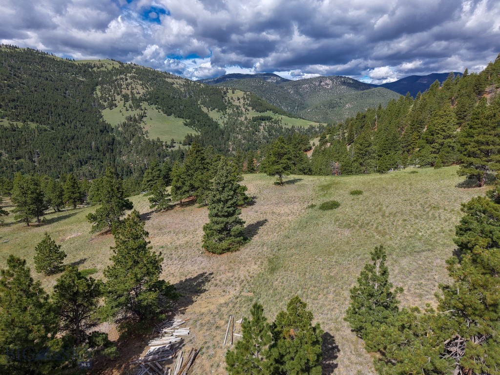This 120± acre property offers multiple building sites, panoramic views, exceptional privacy, and electrical power already on-site. Located approximately 35 minutes from Helena (Google Maps), it combines the tranquility of rural Montana with convenient access to city amenities.

A standout feature is the spring-fed pond, which supports a healthy trout population while enhancing the property's natural beauty and providing valuable wildlife habitat. Water features like this are uncommon in the region and add to the property's recreational appeal.

Outdoor enthusiasts will appreciate the proximity to Holter Reservoir, Canyon Ferry Lake, Lake Helena, and the upper Missouri River, renowned for outstanding rainbow and brown trout fishing. Boating, kayaking, hiking, and other recreational opportunities are all within easy reach.

The property directly borders Montana State Trust Lands, providing immediate access to additional public acreage for hiking, horseback riding, hunting, and wildlife viewing. Located within a general hunting district for deer and elk, the property offers excellent opportunities to enjoy Montana's abundant wildlife and expansive public lands.

An older metal building provides practical infrastructure and may be utilized for equipment storage, livestock shelter, hay storage, or workshop space with some maintenance or improvements.

Combining multiple building sites, on-site power, a spring-fed trout pond, direct public land access, panoramic views, and convenient proximity to Helena, this property presents an outstanding opportunity to build a home, recreational retreat, or hunting base in the heart of Montana's outdoor country.