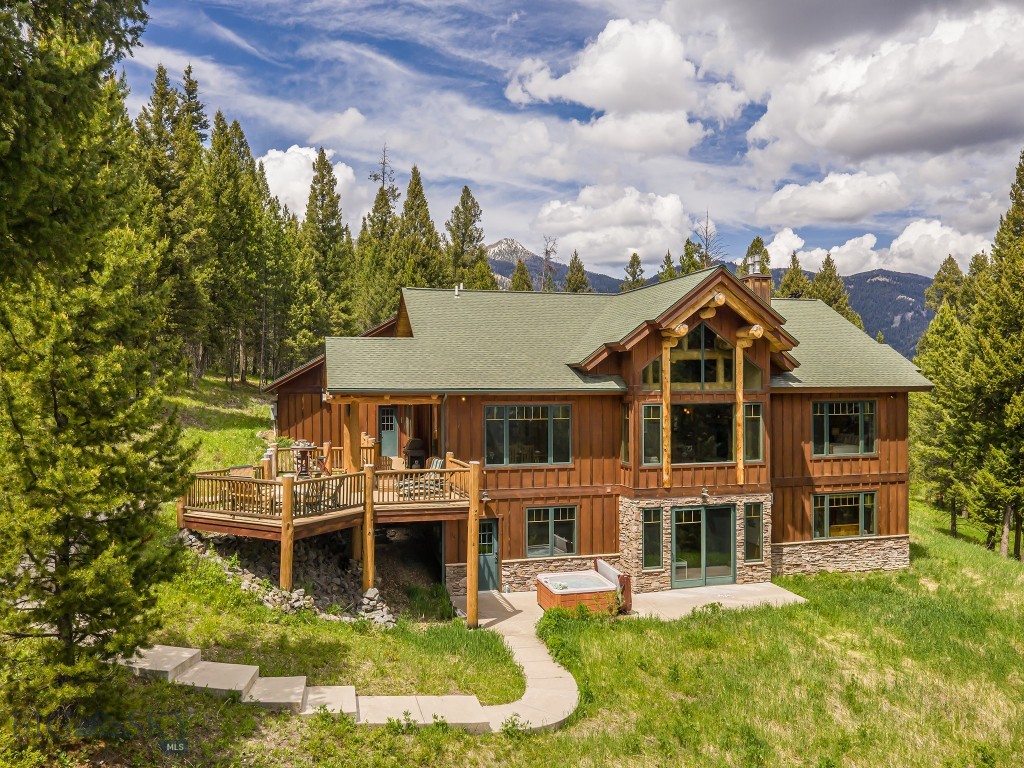 This stunning home, built by Blue Ribbon Builders, is nestled into a grove of old growth pines on a 20 acre parcel just minutes to Town Center. The southern exposure bathes the primary suite and most of the living spaces in sunlight while affording expansive views. The vaulted ceiling, log accents and propane fireplace in the great room create cozy seating areas adjacent to the open dining kitchen entertaining area. During the summer months, the expansive outdoor areas move family and guests into the surrounding nature, where it is common to see elk, deer and the occasional bear. 

This is the quintessential Big Sky getaway featuring the privacy of a large parcel with the proximity of all amenities of the Meadow Village and Town Center. Blue ribbon fly-fishing on the famed Gallatin River is just a few miles away. Yellowstone National Park will be your new back yard, which you can visit in under an hour's drive. Ski the slopes of  Big Sky Resort or the cross country trails of Lone Mountain Ranch. Enjoy Big Sky in every season. Come experience the free weekly summertime concerts, Farmer's Market, professional rodeo events, skijoring, music festivals, endless hiking, biking and fun on the river. Make 725 Sandhill Road in Big Sky your basecamp to endless fun and adventure!

Offered furnished, excluding artwork, personal items.