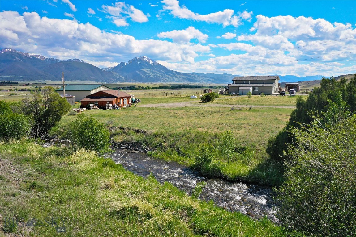 Set against the backdrop of Paradise Valley's mountain ranges, this nearly 20-acre offering captures the Montana lifestyle so many people are searching for. Located just 30 minutes from Livingston and 45 minutes from Gardiner and Yellowstone National Park, you'll have the space and privacy of country living while still being close to recreation, dining and everyday conveniences. The expansive deck takes full advantage of the views across Paradise Valley and offers a great place to unwind after a day spent fishing nearby, exploring Yellowstone, horseback riding or simply enjoying life at home. With four separate living spaces, the possibilities here are hard to beat. Live in the owner's residence while generating income from the two additional apartments and detached cabin, or maximize the investment potential by renting all four units. Whether you're looking for supplemental income, employee housing, a multigenerational setup or a place that can adapt to your changing needs over time, this property gives you options. The main home is comfortable and inviting, featuring wood finishes, vaulted ceilings, a cozy wood stove and large windows that bring in plenty of natural light and showcase the surrounding views. It's the kind of place that you feel can be really lived in, where muddy boots by the door are part of everyday life. The newer riding barn and shop is a true Montana bonus. Complete with an indoor arena and generous shop space under one roof, it's ready for riding, equipment, recreational toys, projects or the workshop you've always wanted. Whether you're an equestrian, hobbyist or simply appreciate having room to spread out, you'll find plenty of ways to make it your own. Opportunities like this don't come around often. Nearly 20 acres in Paradise Valley with income-producing potential, versatile living arrangements and room for the Montana lifestyle you've been dreaming about.