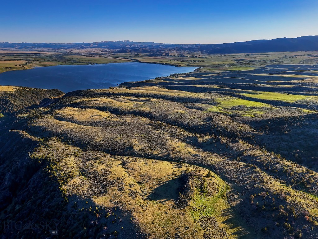 Located on the north shore of Ennis Lake in McAllister, Montana, this legacy property presents a rare opportunity to acquire just over 2,700+/- acres in one of Montana’s most desirable valleys. The offering combines lake frontage, agricultural production, equestrian infrastructure, conservation or development potential, and a fully operational commercial component.  Showing by appointment only.

A working ranch with residential, livestock, and infrastructure elements in place, Lost Heart Ranch anchors the entire offering. It is subdivided into 45 legal parcels, making if a great candidate for a conservation easement, possible development, and generational use. Includes 2,500± SF 4BD/3BA main residence (1994), 2,400± SF equipment shop with attached 2BD/1BA residence (2004), 3,100± SF livestock barn, and 1400± feet of lake frontage.
A rare, turnkey 23.18 acre equestrian facility located on the lake, this component of the offering includes a 6,344+/- SF luxury home with a pool, lake frontage, and full horse infrastructure.
The commercial asset of this property, Lake Shore Lodge offers a strong base for hospitality, storage, and lakefront access with expansion potential. Features 42 full-service RV sites (50 amp), office/store and bathhouse with laundry, 3 dry cabins and 3 additional  4 season rental cabins, room for employee housing, marina with 10 docks and seawall. 2 drain fields and 7 holding tanks with room for expansion. Excellent potential for income generation or private estate repurposing.

With panoramic views in every direction—Lone Peak to the east, the Centennial Mountains to the south, and the rugged Tobacco Root Mountains to the west—the property features diverse topography including productive pasture, riparian corridors, and juniper-covered hillsides. Comprising three primary components—Lost Heart Ranch, Lake Shore Equestrian Estate, and Lake Shore Lodge—this property supports year-round ranching, recreation, and income generation, all just minutes from Ennis and under an hour to Bozeman.