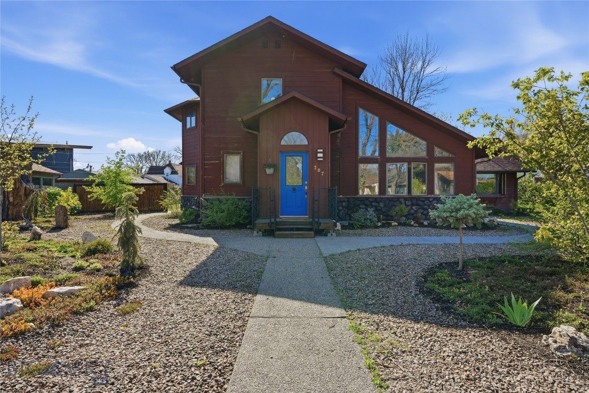 Located in the heart of Manhattan, this one-of-a-kind Craftsman home was designed by well known architect Dave Andreassi. Vaulted ceilings, hardwood floors, and timeless architectural details create an inviting living space. Open kitchen with wood covered ceilings and quartz counters. Step down into the sunken living room with vaulted ceilings and gas stove. The main level primary suite features separate entrances, a gas stove, walk-in closet, and full bathroom offering flexibility for a potential ADU, home business, guest quarters, or multi-generational living. To round out the main level, there is a 2nd bedroom with vaulted ceilings, laundry room, and 3/4 bathroom. Upstairs you'll find an en-suite + another bedroom and bathroom. This 14,000 SF lot occupies 4 city lots. Enjoy the yard, especially the thoughtfully done xeriscape landscaping in the front, extra paved area for extra parking + the detached 780 SF garage. Being just two blocks from downtown Manhattan, you’ll enjoy easy access to the grocery store, restaurants, and local shopping. The property is zoned RT and approved for low traffic business use, creating an opportunity for live/work potential.
