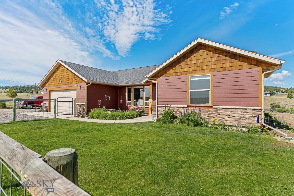 Welcome home, where peaceful country living meets the convenience of modern, one-level living. Situated on 2.9 acres in the desirable Beef Trail Estates Subdivision, this beautifully maintained home, built in 2018, offers the perfect balance of comfort, privacy, and space.

Designed for easy living, the home features 4 bedrooms and 2 bathrooms with an open-concept floor plan that’s perfect for everyday life and entertaining. The spacious primary suite offers a relaxing retreat with double sinks and a beautifully tiled shower. Granite countertops throughout add timeless style, while the great room creates a warm and inviting gathering space. A sliding glass door off the kitchen opens to the deck, where you can enjoy your morning coffee while taking in the peaceful views and watching wildlife wander by.

Outside this property truly shines. Beautiful flower gardens, a dedicated vegetable garden, and a greenhouse provide endless opportunities to enjoy gardening, grow your own fresh produce, or simply relax surrounded by nature. The fenced yard offers space for pets or play, while the nearly 2.9 acre setting provides room to roam without sacrificing the convenience of one-level living. Additional features include a laundry room with closet and a double attached garage.

Whether you’re looking to downsize without giving up space, embrace a quieter lifestyle, or simply enjoy the beauty of Montana living, 1083 Slalom Lane is ready to welcome you home.