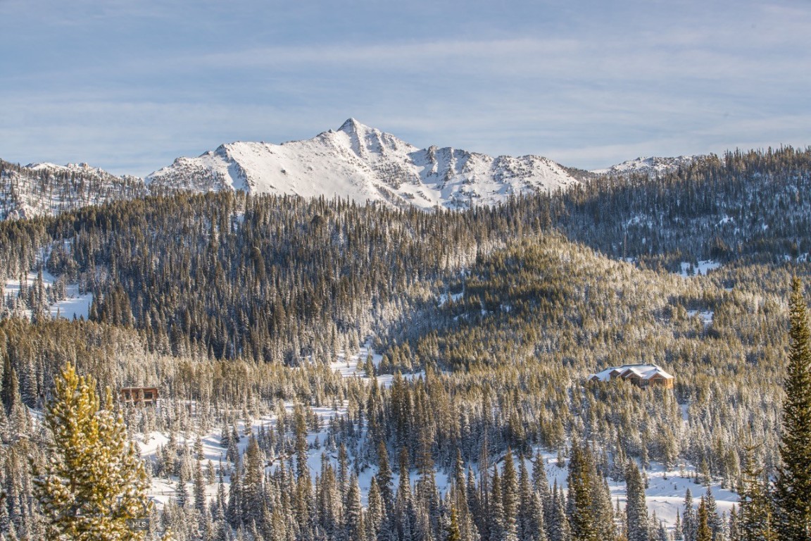 An exceptional opportunity to own a premier 5-acre homesite in the highly sought-after Beehive Basin community of Big Sky, Montana. Ideally positioned along Beehive Basin Road, this rare parcel captures unobstructed panoramic views of the iconic Spanish Peaks—delivering the quintessential Big Sky mountain setting and a truly elevated building opportunity.

The gently sloping topography creates an ideal homesite for a custom luxury retreat, legacy estate, or refined mountain modern residence. The natural grade enhances privacy while preserving expansive sightlines, allowing for a thoughtfully designed home that maximizes mountain views, natural light, and outdoor living. With five private acres, the setting offers both space and seclusion—an increasingly rare combination in Big Sky real estate.

Direct access to year-round recreation defines this Beehive Basin location. The renowned Beehive Basin Trail—celebrated for hiking and backcountry skiing—provides immediate access to alpine lakes, wildflower meadows, and breathtaking terrain. In winter, world-class skiing and snowboarding await just minutes away at Big Sky Resort, home to some of the most expansive ski terrain in North America.

Despite its tranquil alpine setting, the property remains conveniently close to Big Sky Mountain Village, One&Only Moonlight Basin, Big Sky Town Center, and the renowned Gallatin River—offering fine dining, boutique shopping, fly fishing, entertainment, and year-round community events. The surrounding Spanish Peaks provide a dramatic four-season backdrop that reinforces both the natural beauty and enduring value of this location.

For buyers seeking a 5-acre homesite with panoramic mountain views, proximity to Big Sky Resort, and access to hiking, skiing, and fly fishing, this offering represents a compelling opportunity to build a custom home in one of the Rocky Mountain West’s most prestigious alpine communities.