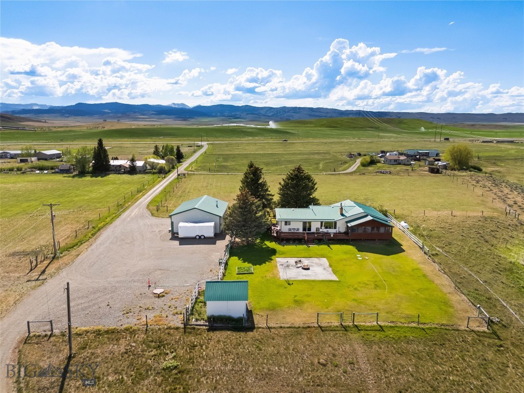 21 McPherson Lane is a remarkable Montana horse property nestled in the heart of the breathtaking Shields Valley. Set on over 46 acres of pastureland with stunning panoramic views of the Crazy, Bridger, and Castle Mountains, this exceptional ranch offers the perfect blend of country living, functionality, and comfort. The spacious 3,645-square-foot home features five bedrooms and three bathrooms, providing ample room for family and guests. The exceptionally maintained and updated basement provides ample possibilities for multi-generational living. Thoughtful updates throughout the home include renovated bathrooms, updated windows and doors, and beautiful flooring, creating a warm and inviting atmosphere. Large windows frame the spectacular mountain scenery, while the sunroom offers the perfect place to relax and enjoy Montana’s unforgettable sunrises and sunsets. Equestrian enthusiasts will appreciate the property’s outstanding horse facilities, including a well-appointed four-stall barn with automatic waterers, hot and cold running water, an insulated tack room, feed storage, and hay storage. Cross-fenced, sub-irrigated pastures with water rights provide excellent grazing opportunities, while the corral system and livestock handling facilities make ranch operations efficient and convenient. Additional improvements include a spacious detached garage and shop building with ample room for vehicles, equipment, and recreational toys. Wildlife frequently visits the property, adding to the serenity and natural beauty of this exceptional setting. Ideally located between Wilsall and Clyde Park, with convenient access to Livingston and Bozeman, 21 McPherson Lane offers the rare opportunity to enjoy peaceful rural living without sacrificing access to modern amenities. Whether you’re seeking a working horse property, a private ranch retreat, or a place to embrace the Montana lifestyle, this extraordinary property delivers it all.