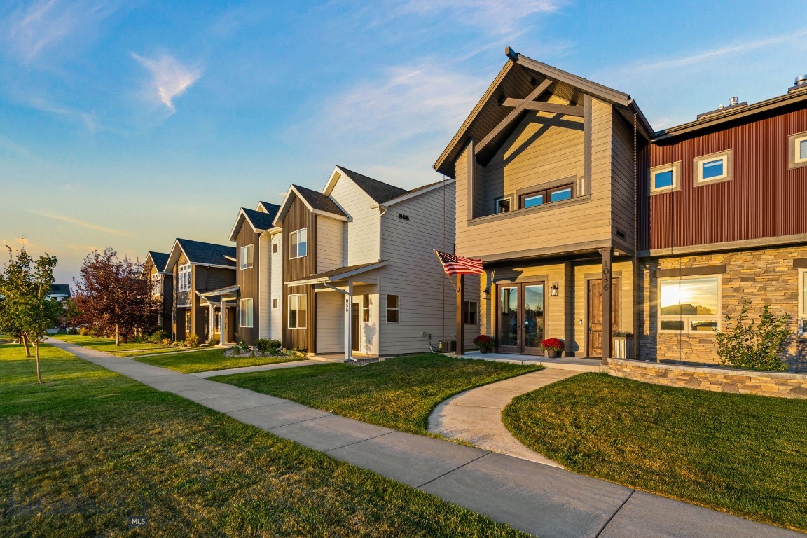 Newer Greater Price!!! Custom real Montana feel townhome in the heart of Bozeman. Minutes from Main, 19th and 7th. 15 minutes to BZN airport. Across from a 2.75 acre park. This 3 bed/2.5 bath, 2500 sq ft home went through an extensive remodel in 2022 and has been lightly lived in since then. Inside this beautiful home you will find reclaimed antique timbers, 2 story stone fireplace, professional lighting design by renowned artisan Ironglass Lighting, custom designed hand hammered metal railings /accents, a stunning kitchen hood and a one-of-a-kind primary suite vanity that is a must see! Inviting entry has radiant floor heat and a gorgeous office with a huge rustic timber door. The kitchen boasts leathered granite countertops with black stainless profile appliances, as well as a pot filler and cabinet lighting. The kitchen/living/dining are open and inviting. The gas fireplace provides a cozy, warm winter hideaway while the summer months can be enjoyed via 2 main level porches and 2 upper level decks including one off the primary that will provide a quiet setting to enjoy the beautiful Montana sunsets over the park. In addition to the private deck, the primary bedroom also boasts a luxurious walk-in closet, huge soaking tub, 6 showerhead Montana Travertine tiled shower and heated floors. The two guestrooms each have walk-in closets as well as a nicely appointed guest bath with a stone vessel sink and more Montana Travertine tile. The upper level entertainment area includes a wet bar with minifridge, surround sound theater system with a 75" Bavaria television. 
This home can be purchased furnished to provide a nearly turnkey property.