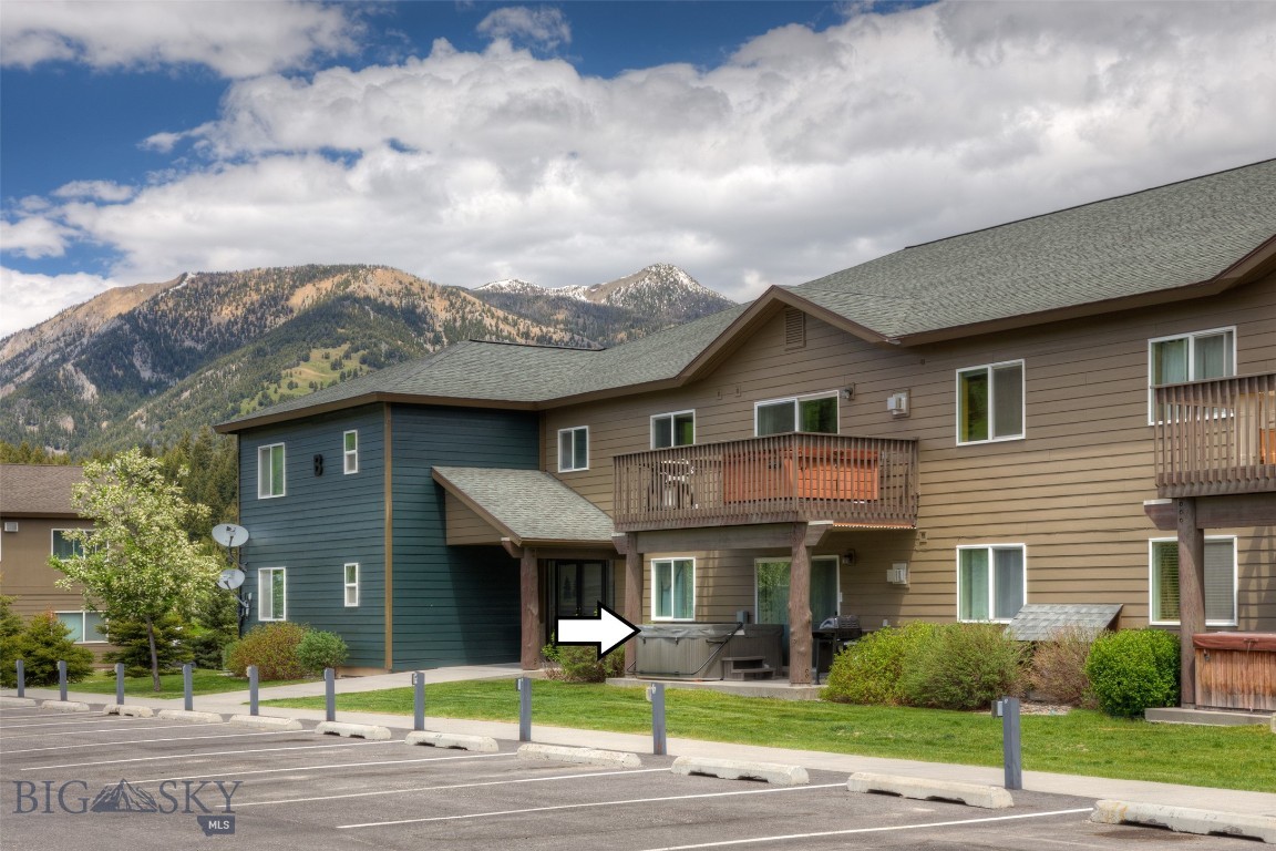Beautifully upgraded and turnkey ground-floor 2BR/2BA Firelight Meadows Condo. This fully furnished unit offers 2 ensuite bedrooms/bathrooms, an open-concept living and kitchen area, a propane fireplace, upgraded flooring and stainless steel kitchen appliances creating a beautiful finish package, laundry, pantry, a private walk-out covered patio with a hot tub and room for seating, and a dedicated parking spot. Conveniently located near the Town Center for shopping and community events, and a walking/biking trail to the popular Ousel Falls Trail. Big Sky Skyline free shuttle service to the mountain. Short-term rentals are allowed, and this unit has a rental history. Easy living for a full-time resident or vacation owner looking to use and enjoy and/or short-term rent as desired. Don't miss this opportunity!