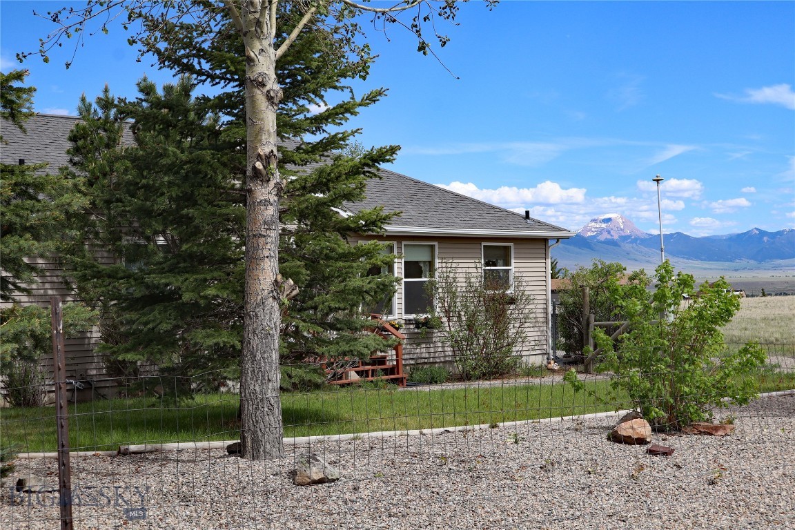 Incredible views of multiple mountain ranges (The Madisons, The Gravellys, & The Tobacco Roots) from this 6+ acre location that is less than 10 minutes to downtown Ennis.  Enjoy making this well maintained 5 bedroom - 3 bath your home base as you fish nearby rivers, snow ski, hunt, hike, or use your side by side on miles of open roads.  The home is partially hidden in mature landscaping (trees on drip, wildflower & perrenial flower beds) so you have the very best of all worlds.  The open floor plan on the main floor (living room (with propane fireplace), dining area, and kitchen are the center of the home with the primary bedroom having it's own access onto the eastern deck.  The ensuite bath has both a shower and jetted tub with an easter view, along with a walk-in closet.  Two more bedrooms on the main floor are currently being used for an office & a work out room creating the perfect space for a single person or couple.  Need more room for guests?  The basement has additional 2 bedrooms, large family room, and another full bath.  You are an hour from Yellowstone National Park & Bozeman's Airport.  Light covenants allows for your animals (horses, pets & chickens) and also short term rentals.  In Montana it is not just buying a property it is purchasing your new lifestyle!