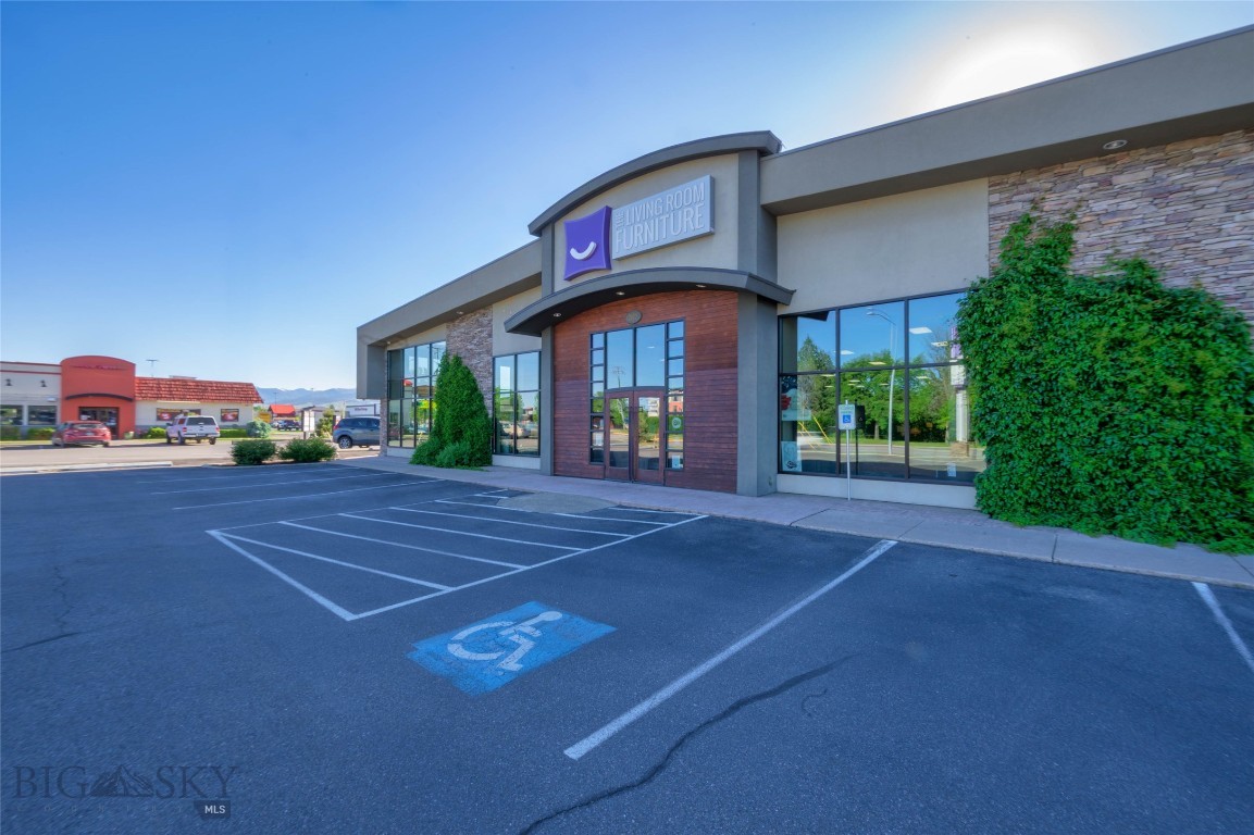 South Reserve St. commercial opportunity offering a highly functional combination of showroom, retail, office, and warehouse space in one of Missoula’s most visible commercial corridors. Situated on approximately 1.14 acres, this 28,512 SF building is currently configured with an expansive customer-facing showroom, large storefront windows, mezzanine/display areas, private office and administrative areas, breakroom, storage, and rear warehouse space. The building’s layout provides excellent flexibility for an owner-user, investor, or business needing both high-exposure retail presence and true back-of-house operational capacity. The rear warehouse area includes overhead door access, loading functionality, high-volume storage, and room for inventory, fulfillment, service, or light distribution uses. The property benefits from dedicated on-site parking, prominent signage, strong visibility from South Reserve Street, and proximity to major retailers, restaurants, service businesses, and established residential neighborhoods. C2-4 zoning allows for a broad range of commercial uses, making this a compelling option for large-format retail, furniture/home goods, flooring, building materials, outdoor recreation, specialty retail, contractor supply, showroom/warehouse, or adaptive reuse. Offered at $4,975,000. Buyer to verify all building, zoning, use, and property information to their satisfaction.