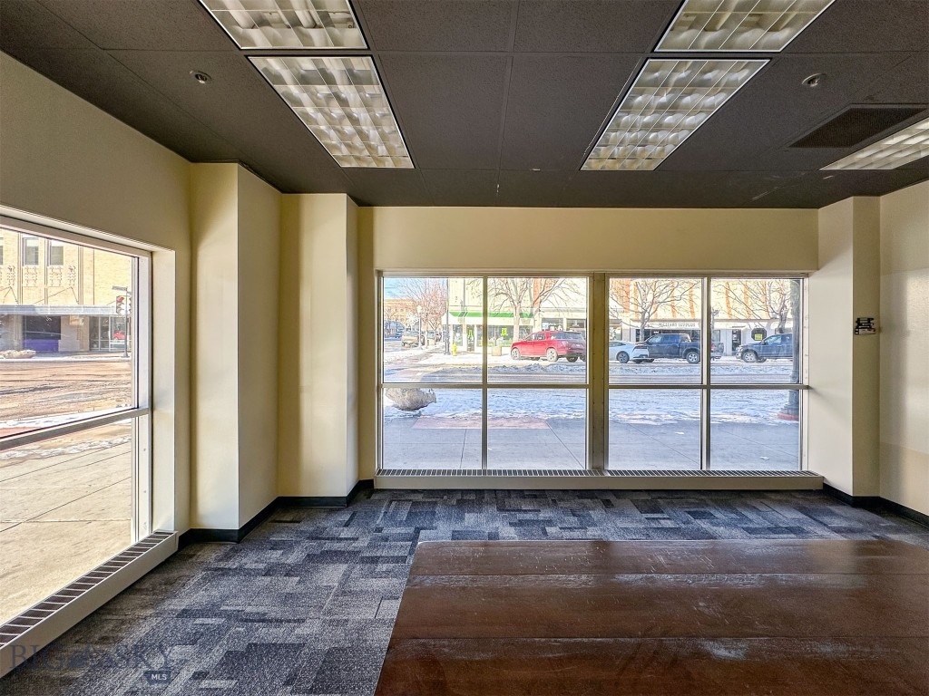 If you are looking for high visibility, and traffic counts in the downtown Great Falls core, this is IT! The modern AND historic building has this 4,000 sq ft of floor space on the ground floor that captures Central Ave and 4th St North attention with its long expanse of big windows. Previously, the versatile space was leased to a call center, but would be ideal for retail, bar/restaurant/brewery, law firm, medical services, government, general offices, and so much more. This space specifically is the corner space with lobby, reception, conference and offices. Also, it enjoys an extensive fiber optic system and uninterrupted power with a back-up generator. Previous tenant made pricey improvements that pass to new tenant. Landlord can rebuild to suit and/or you can choose from several other configurations, and sizes, if you need more than 4,000'. Covered and open parking available, but not included in lease price. Air cooling system in place. Dozens of office chairs, cubicles, televisions, kitchen equipment, other furnishings, shelving, monitor holders are available, but not included in the lease. Carpet and laminate are current floor coverings. Women's bathroom is handicapped accessible and has 10 stalls and 6 sinks. Men's is handicap accessible with 2 stalls, 3 urinals, and 3 sinks. Opening up the mezzanine would create 19 foot ceiling heights. Building formerly dubbed the historic Strain building and was once Sears. Building currently home to an event center, the bar Elevation, golf simulators, counselors, attorneys, and more. Property manager on site. Loading docks are currently shared, but landlord could convert to separate and private, if new tenant needs. Building is NOT FOR SALE. This is commercial lease only. Also, see additional space, for lease, on separate floors, under separate listing.