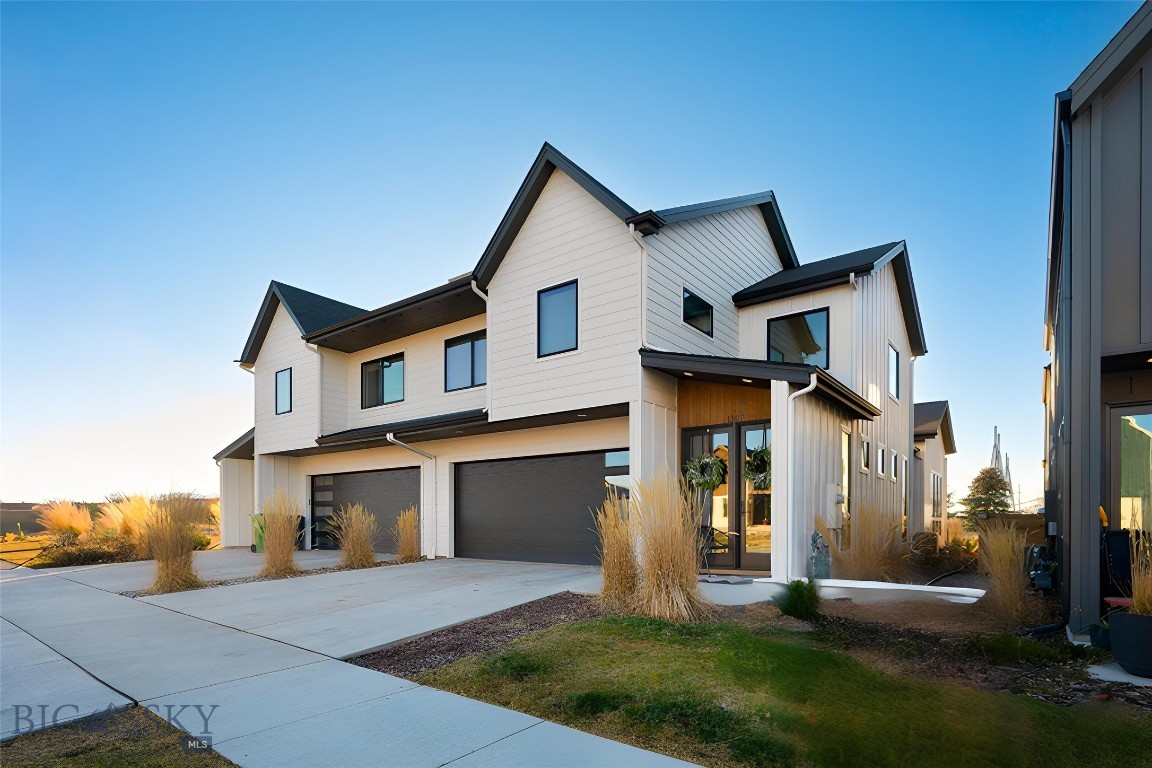 Welcome to 1327 Windrow Drive, a beautifully designed luxury townhome in the coveted Flanders Mill subdivision. This luxurious 3-bedroom, 2.5-bath townhome offers 1,911 square feet of thoughtfully designed living space, combining elevated finishes with effortless, low-maintenance living. Ideally suited for those who value convenience, flexibility, and refined design, this home allows you to enjoy everything Bozeman has to offer—without the time-consuming upkeep of a traditional single-family residence. The main level features a highly desirable primary suite with a spa-inspired ensuite bathroom and heated floors, providing comfort and functionality for everyday living. The open-concept layout showcases elevated finishes throughout, including quartz waterfall kitchen countertops, custom built-ins, a striking steel staircase, and expansive windows that fill the home with natural light. A cozy gas fireplace with mantel anchors the living space, complemented by high-end window shades and refined architectural details. Upstairs, two spacious bedrooms, a full bathroom, and a lofted living area offer flexibility for a second lounge, media space, or home office, along with a conveniently located laundry room. An attached two-car garage adds everyday practicality and ample storage. Located in Flanders Mill, this home offers access to community parks, trails, and ponds, with easy proximity to downtown Bozeman, shopping, dining, and outdoor recreation. Whether used as a full-time residence or a lock-and-leave option, this low-maintenance luxury townhome delivers a refined Montana lifestyle.