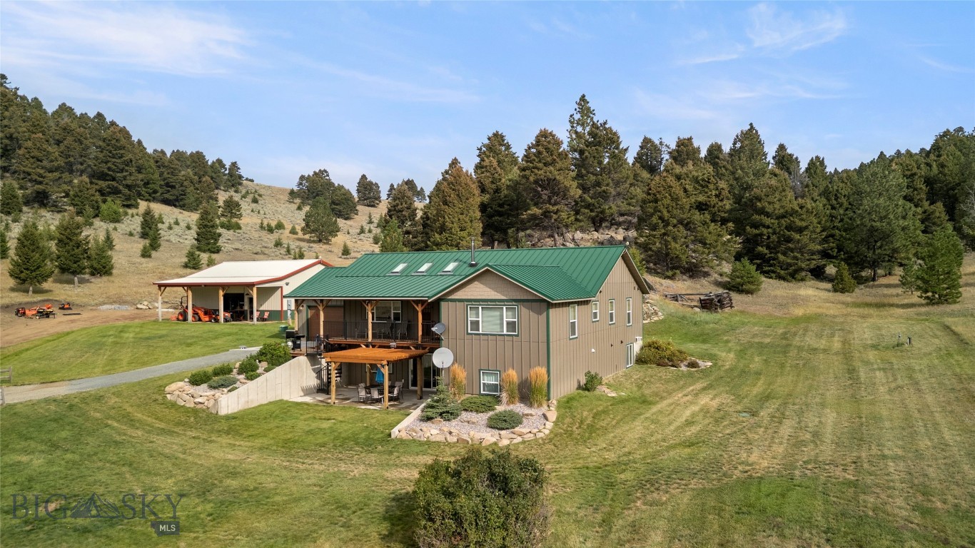 Set on 20 pristine acres with truly unforgettable views, this custom-built 2018 home offers a rare blend of privacy, functionality, and direct access to Montana’s great outdoors. Bordering State Land, BLM, and Forest Service ground, you’ll enjoy seamless access to thousands of acres right out your back door. Located in the highly desirable Aspen Valley Ranch subdivision in Boulder, MT—conveniently positioned between Helena and Butte—this 4-bedroom, 3-bath home is thoughtfully designed for comfortable main-level living. The open floor plan features a chef’s kitchen equipped with a Thermador oven and convection microwave/oven, flowing effortlessly into the main living spaces—perfect for both everyday living and entertaining. The primary suite captures the sweeping views, creating a peaceful retreat, while the expansive family room offers additional space to gather, complete with sliding glass doors that open to a patio and pergola—an ideal setting to take in the surrounding landscape. Outdoor living truly shines here, with wide-open space, incredible vistas, and room to enjoy it all. A 1,200 sq ft heated shop with an office and oversized doors provides incredible space for vehicles, equipment, or hobbies.  There is a plow truck, tractor (plus implements), and many of the tools in the shop that are included with the sale.