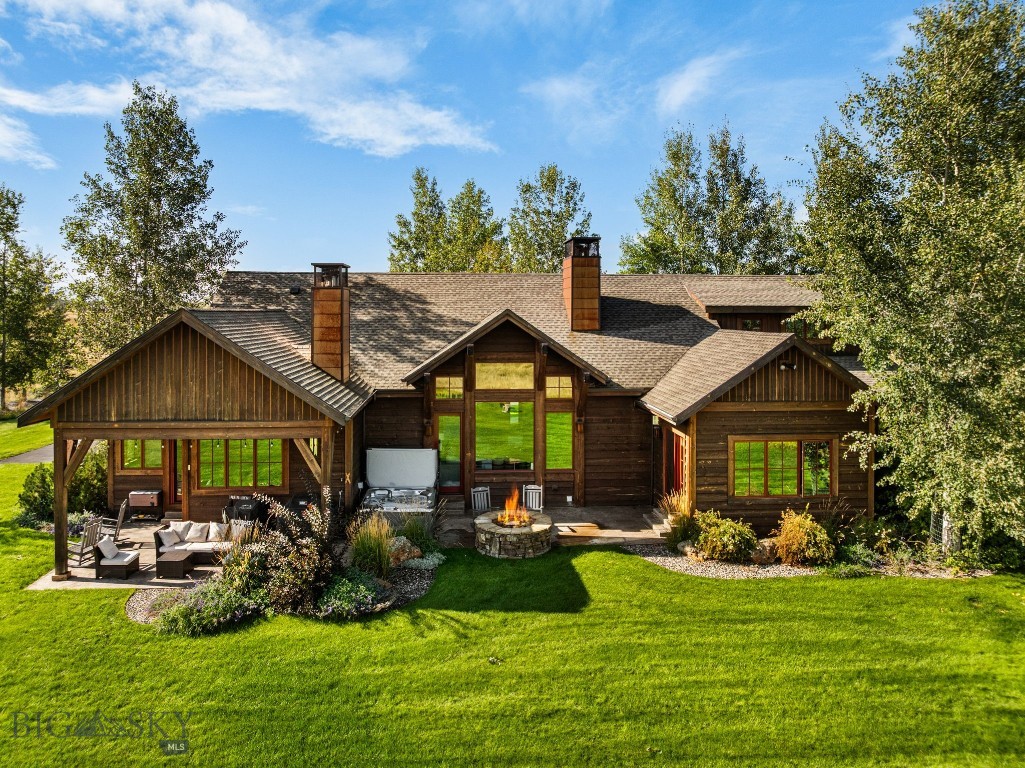 Positioned on 12 scenic acres and surrounded by neighborhood open space, this exceptional Montana property captures sweeping 360-degree views of the Bridger Mountains and surrounding ranges, farmland, and the wide-open landscape that truly defines the region. Designed by Brechbuhler Architects and masterfully built by Teton Heritage Builders, this custom home was thoughtfully crafted to embrace its remarkable setting, offering a seamless balance of refined comfort, exceptional craftsmanship, and connection to the outdoors. Inside, expansive windows frame the surrounding vistas while warm natural materials and vaulted ceilings create an inviting mountain-modern atmosphere. The main living spaces are designed for both quiet retreat and effortless gathering, anchored by a striking floor-to-ceiling stone fireplace and flowing naturally into the kitchen and dining areas, perfect for hosting family and friends after a day spent exploring the outdoors. The main-level primary suite offers a private sanctuary with its own fireplace and spa-inspired bathroom, while additional guest spaces and flexible living areas provide comfort and privacy for visitors, as well as multiple options for a work-from-home lifestyle. The lower level is designed with entertaining in mind, featuring a generous lounge space, a fireplace, a wet bar, and a temperature-controlled wine room—ideal for relaxed evenings and memorable gatherings. Outdoor living is equally inviting, with a spacious patio, built-in grilling area, hot tub, and wood-burning fire pit set against the backdrop of Montana’s expansive skies. The acreage offers room to roam and is well-suited for equestrian use, allowing for horses and future improvements such as a barn or guest house, ideal for those seeking a true Montana lifestyle. The property also includes a storage shed and ample space for continued customization. Surrounded by open space yet just a short drive to Downtown Bozeman, the Bozeman Yellowstone International Airport, and year-round recreation, this property offers a rare blend of privacy, views, and timeless Montana living.